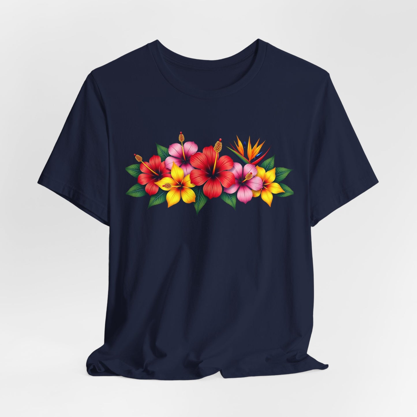 The Tropical Floral Unisex T-Shirt is a navy blue summer shirt with bold red, pink, and yellow hibiscus flowers plus green leaves across the chest—ideal for boho fashion lovers seeking a bright, vibrant style.