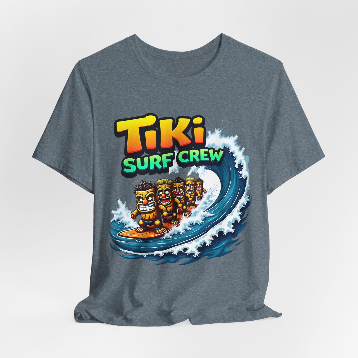 The Tiki Surf Crew Graphic Tiki T-Shirt is a fun unisex short sleeve jersey featuring vibrant cartoon tiki figures surfing a big wave with “Tiki Surf Crew”—perfect for beach lovers and fans of surf culture.