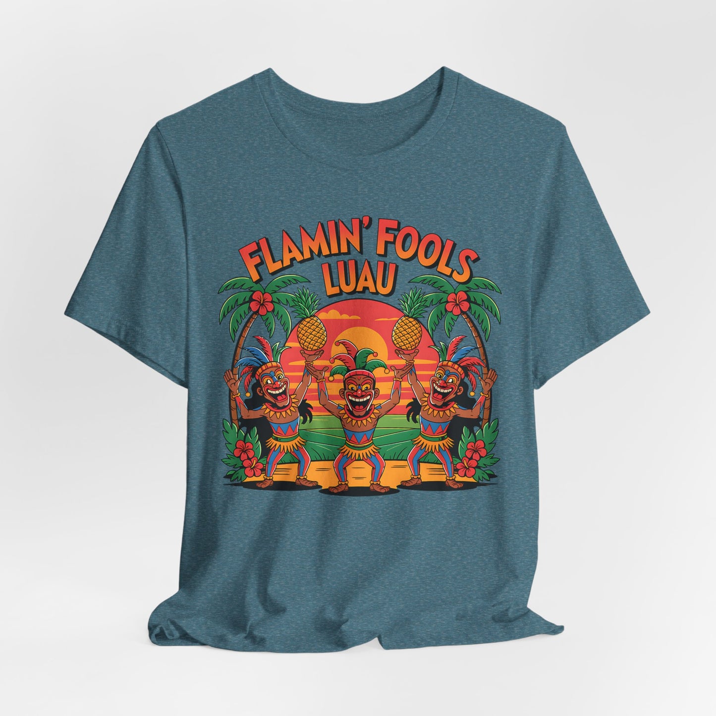 The Flamin Fools Luau Tiki T-Shirt is a blue unisex jersey featuring three dancing tiki figures, palm trees, and a sunset with “Flamin’ Fools Luau” in bold orange and yellow letters—ideal for tropical or beach parties.