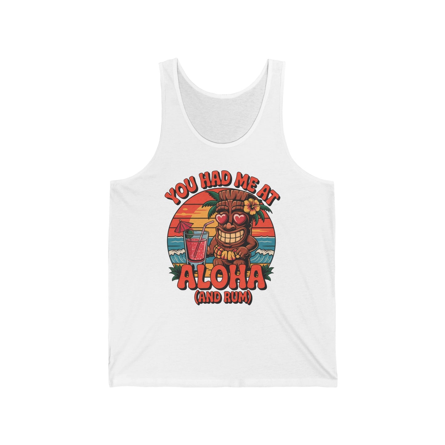 The Aloha Tiki Tank Top is a white unisex jersey with a colorful tiki, heart-shaped eyes, cocktail, palm trees, ocean, and sunset. You had me at Aloha (and rum) text adds beach culture and tropical vibes to any day.