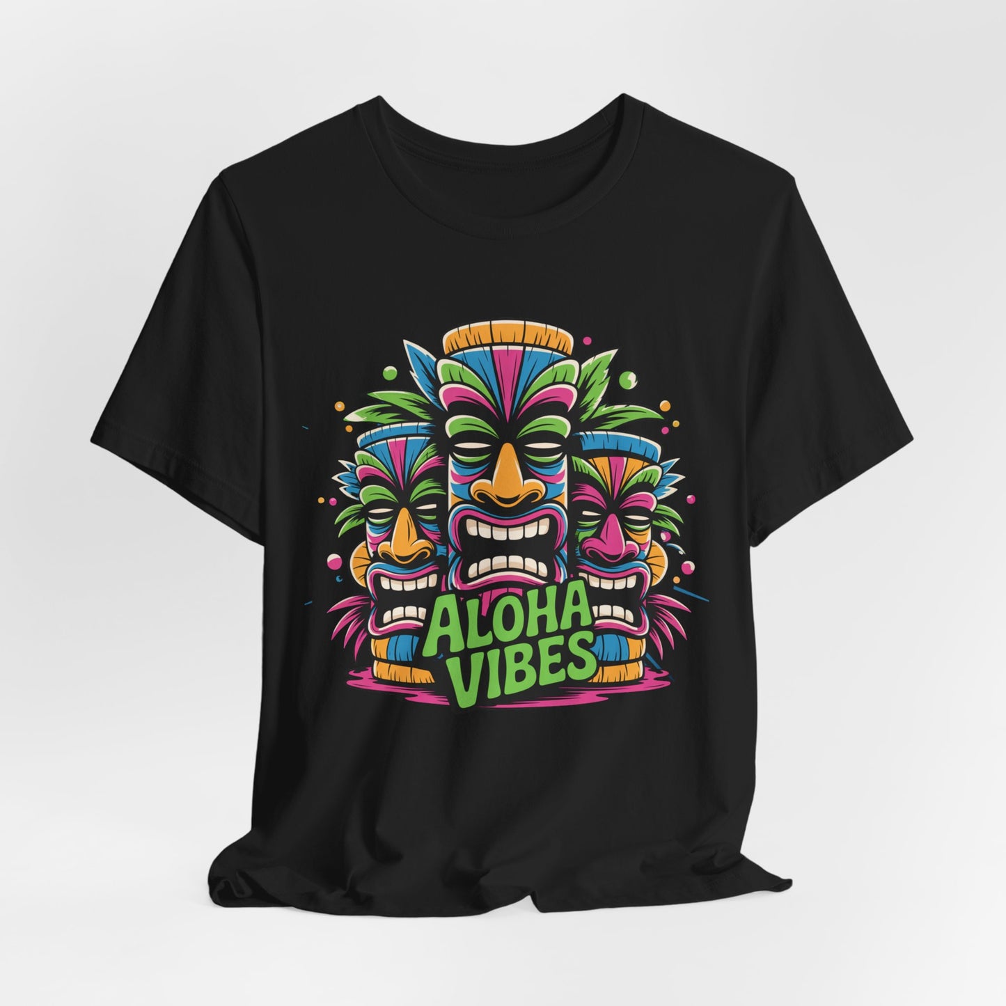 The Aloha Vibes Unisex Short Sleeve Tiki T-Shirt features a vibrant graphic of three Tiki masks and Aloha Vibes text, making this comfy cotton tee perfect for beach lovers, tropical getaways, summer festivals, and festive occasions.