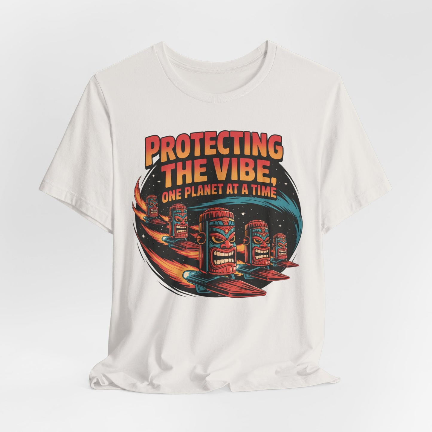 The Protecting the Vibe Unisex Tiki T-Shirt is an eco-friendly graphic shirt featuring three colorful tiki faces on surfboards in space with the bold text Protecting the Vibe, One Planet at a Time—ideal for eco-conscious individuals.
