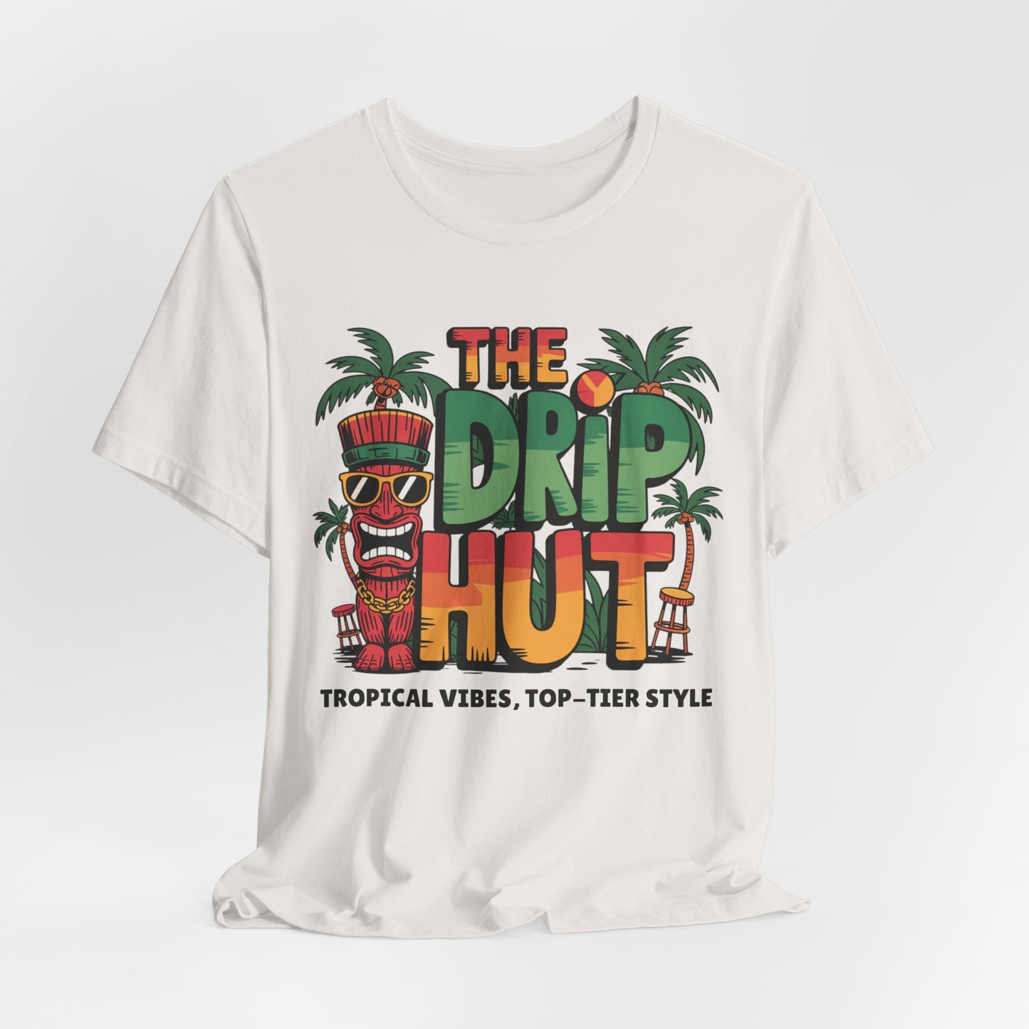 The Tropical Vibes Unisex Tiki T-Shirt - The Drip Hut features colorful text, palm trees, a tiki face in sunglasses, beach chairs, and the tagline Tropical Vibes, Top-Tier Style—perfect for island vibe tee lovers.