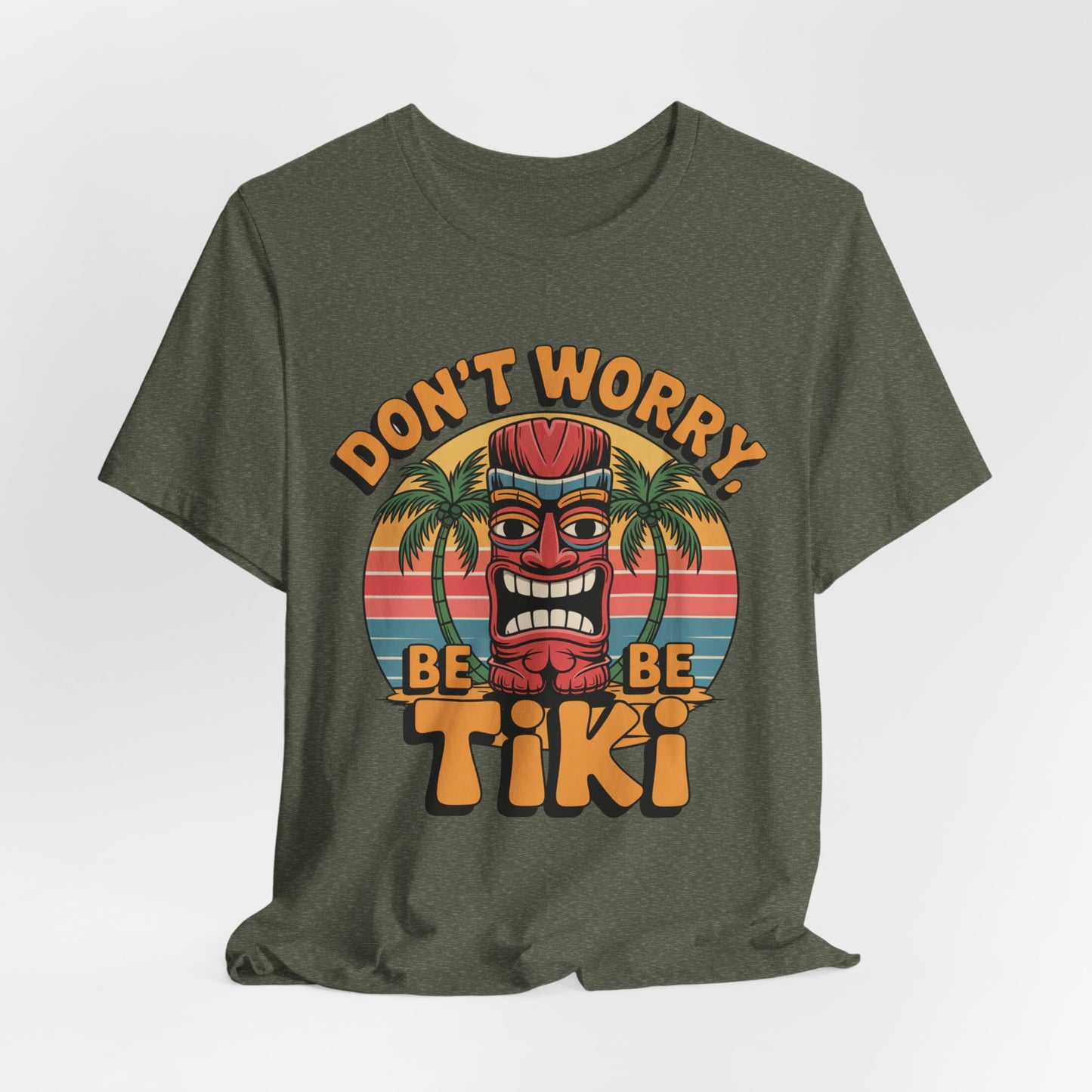 Add tropical style to your look with the Tiki Vibes Unisex Jersey Tiki T-Shirt, featuring a colorful tiki face, palm trees, sunset, and playful DONT WORRY, BE TIKI graphic for a laid-back vibe.