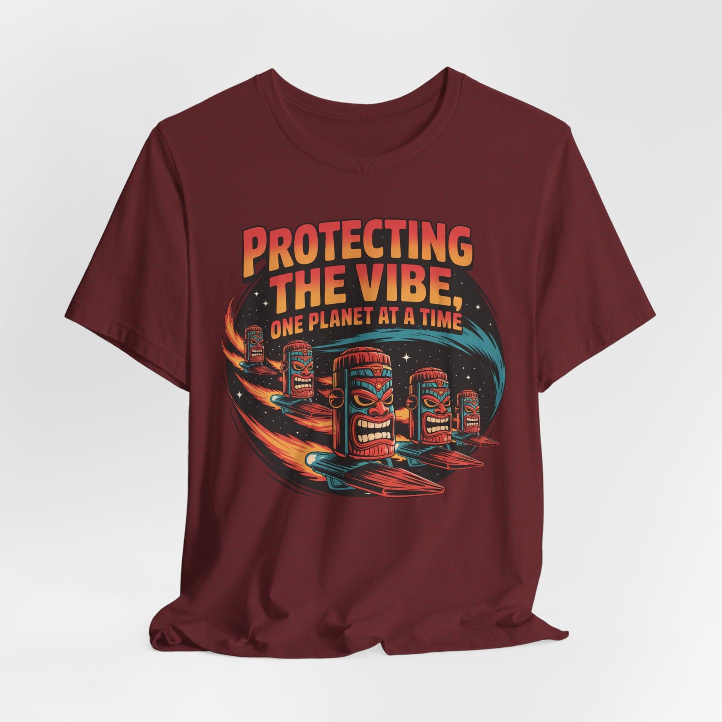 The Protecting the Vibe Unisex Tiki T-Shirt – Eco-Friendly Graphic Shirt features playful tiki heads on surfboards in space with Protecting the Vibe, One Planet at a Time—a bold choice for eco-conscious style.