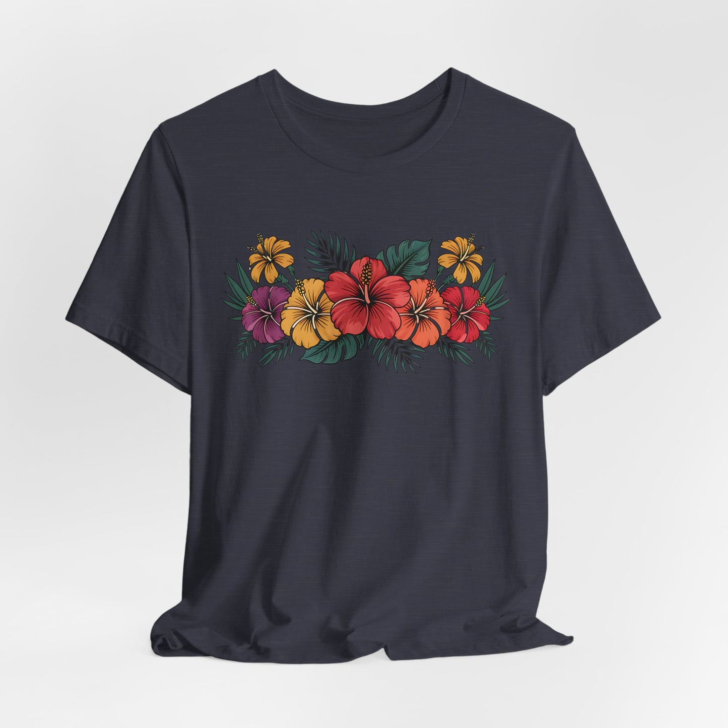 The Tropical Floral Unisex T-Shirt - Perfect for Summer Days features a soft Airlume combed cotton build and a vibrant chest design with red, yellow, and purple hibiscus flowers and green leaves.