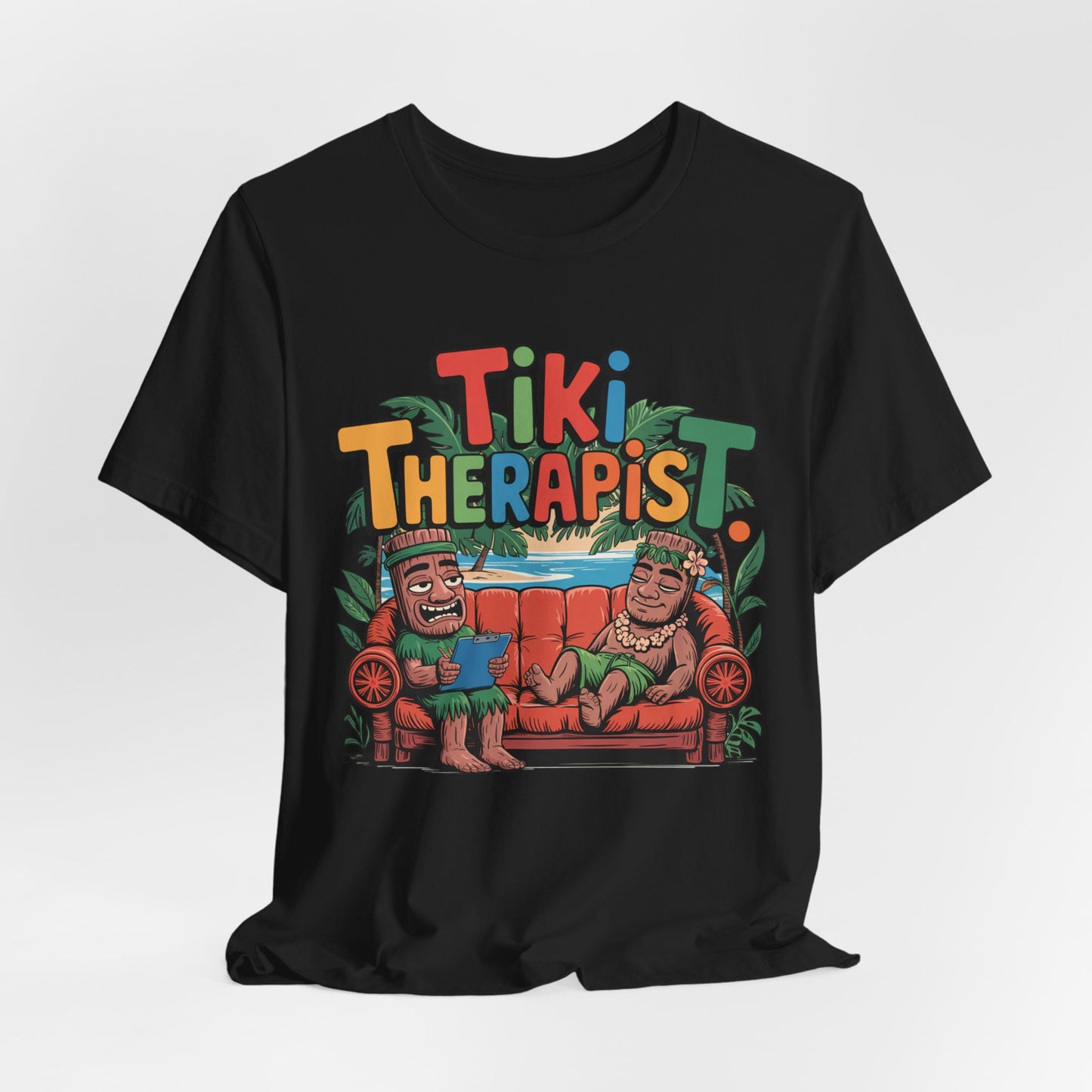 The Tiki Therapist Unisex Tiki T-Shirt is a fun Hawaiian graphic tee for beach lovers, featuring two smiling tiki figures on a red couch with Tiki Therapist above, tropical leaves accents, and made from breathable cotton for all-day comfort.