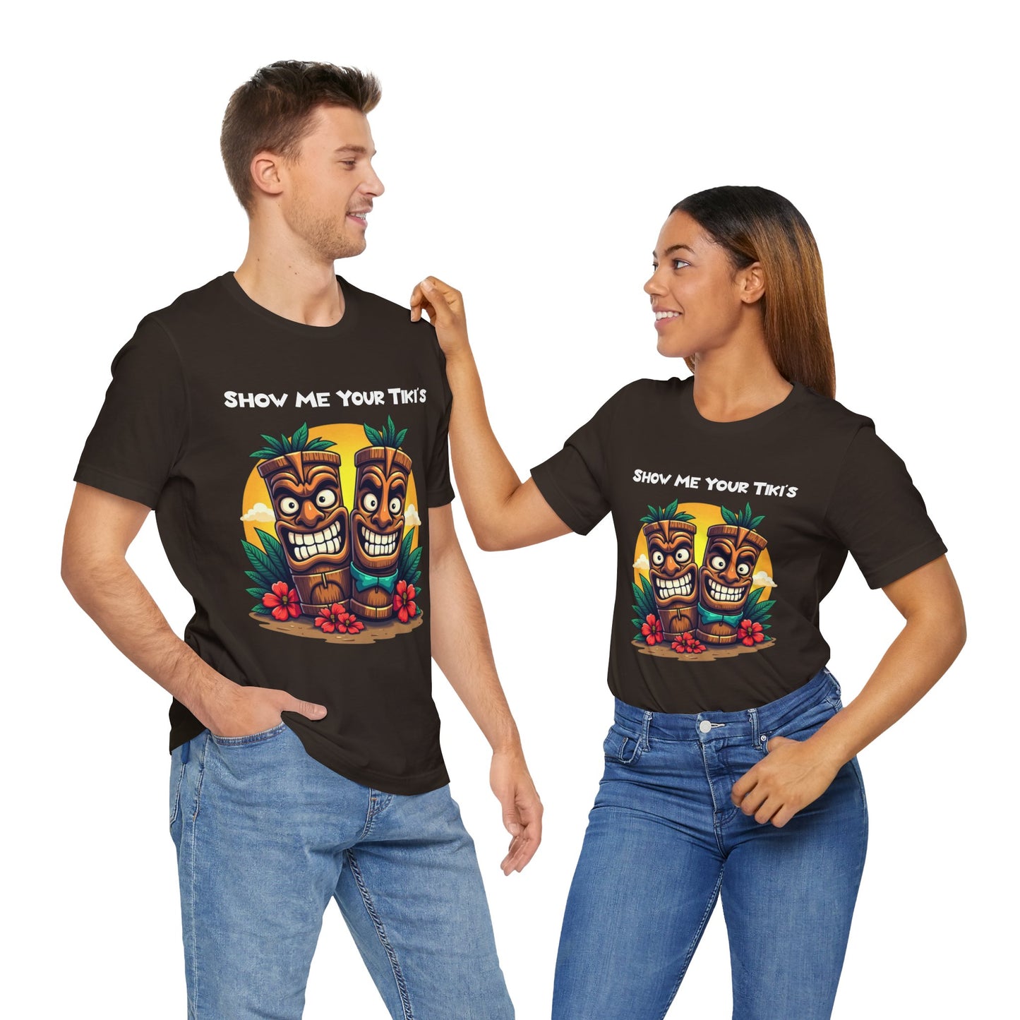 A man and woman smile at each other in Tiki Fun Unisex Jersey Short Sleeve T-Shirts, made from soft Airlume cotton. Their shirts feature a vibrant tropical design with the text SHOW ME YOUR TIKIS on white backgrounds.