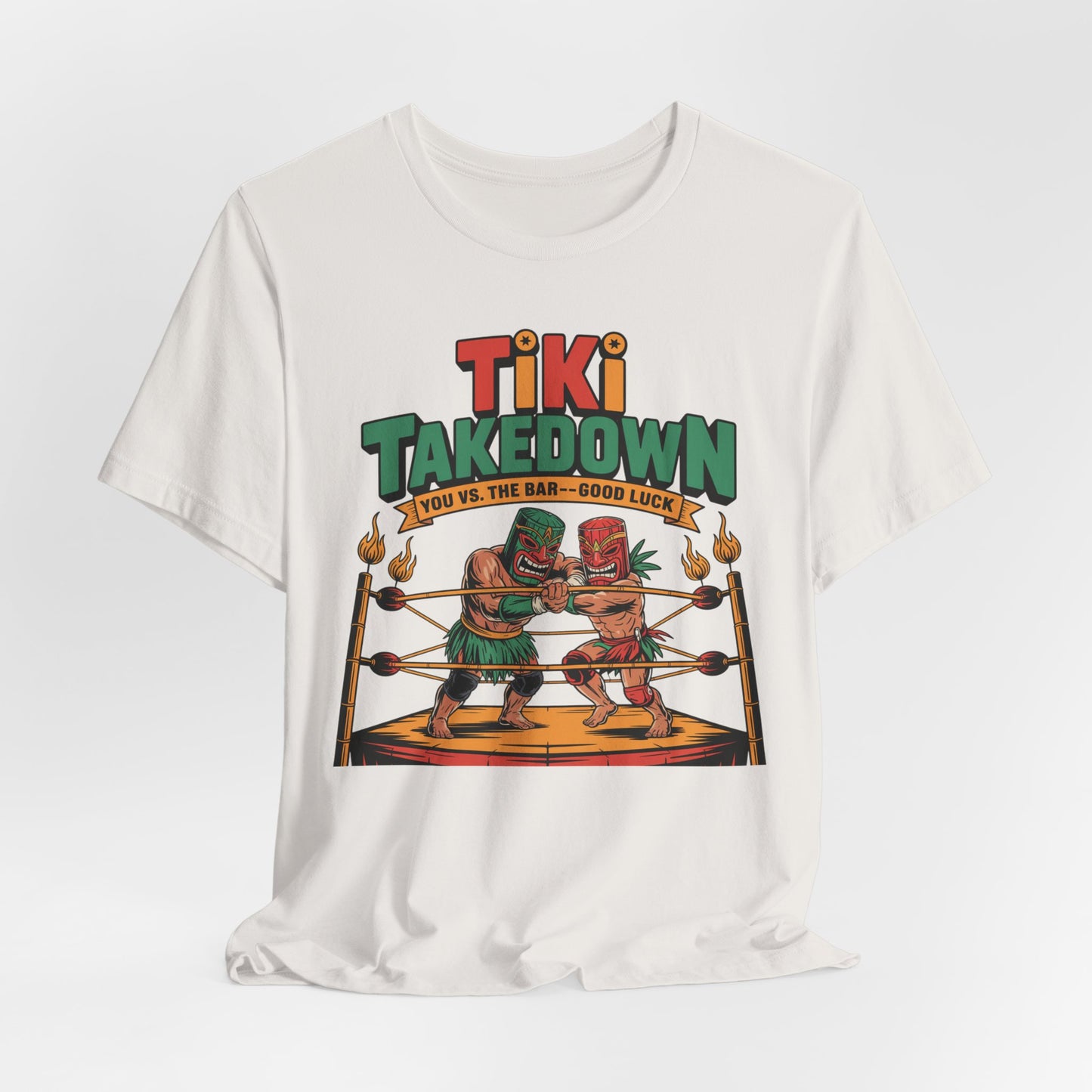 The Tiki Takedown Unisex Jersey Tiki T-Shirt is a white, soft Airlume cotton tee for bar lovers, featuring two tiki characters boxing in a ring with “Tiki Takedown” above and “You vs. the Bar—Good Luck!” below.
