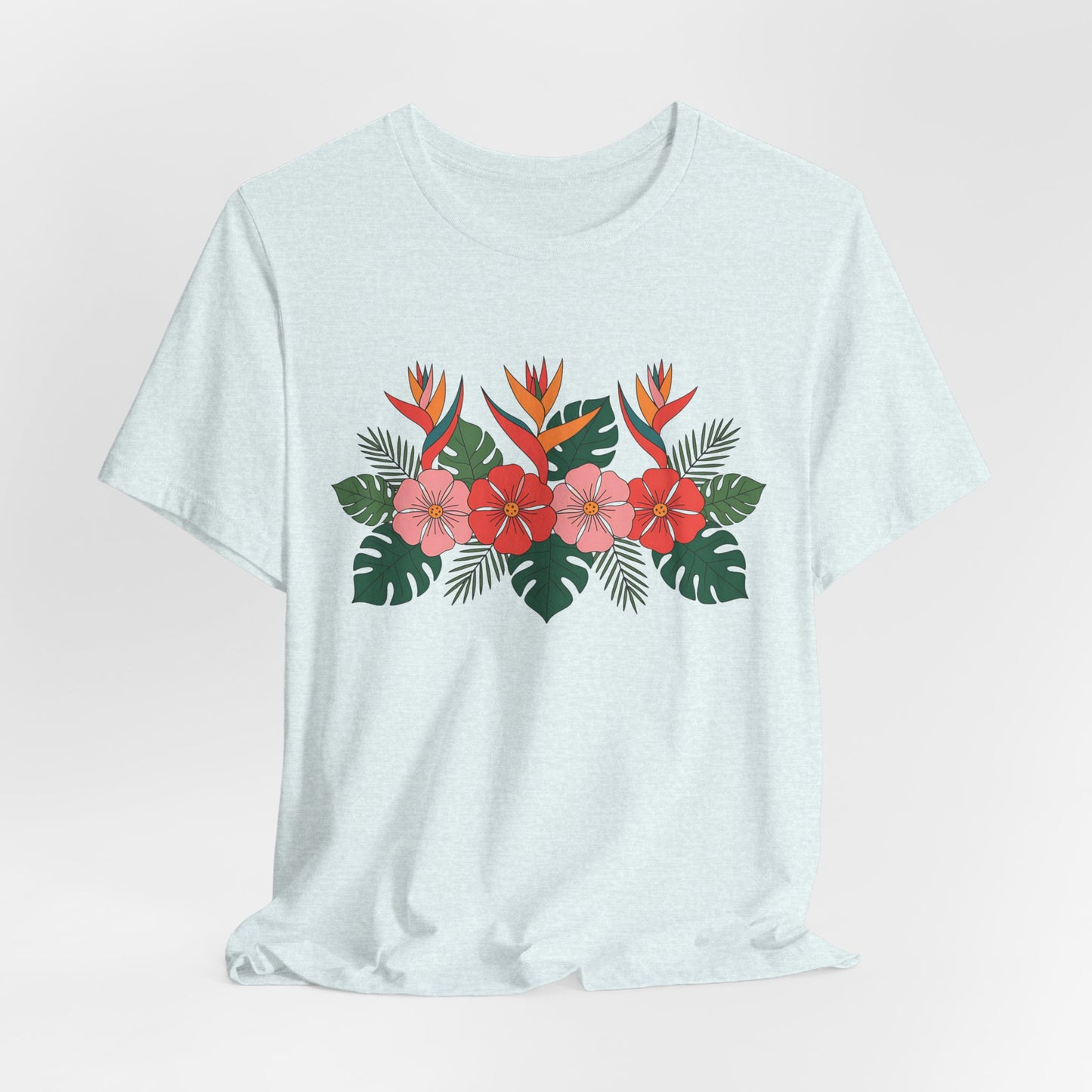 The Tropical Floral Unisex T-Shirt – Perfect for Summer Celebrations features a vibrant floral print with red hibiscus, orange bird-of-paradise, and green palm leaves on breathable fabric for all-day comfort.