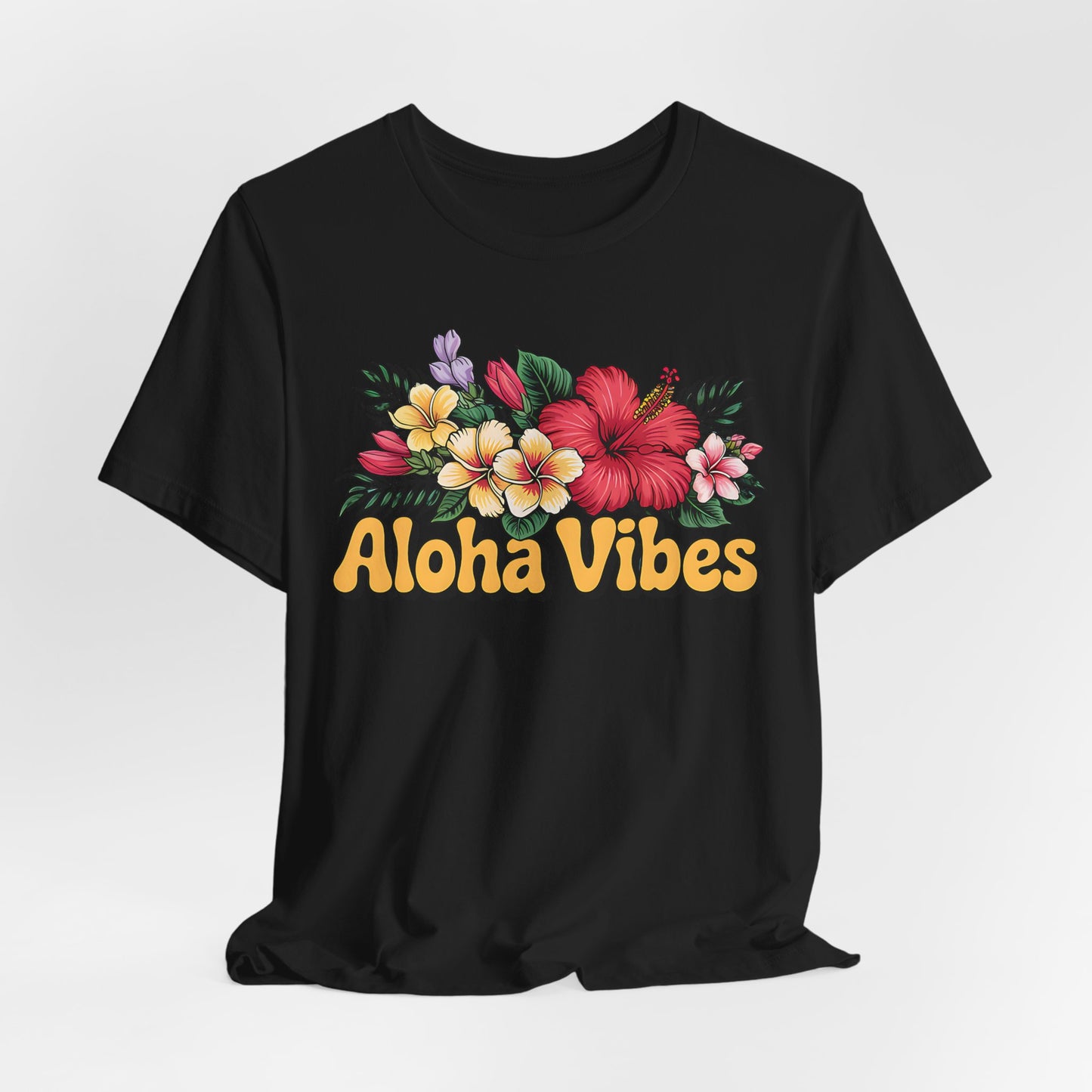 The Aloha Vibes Floral Unisex T-Shirt for Island Vibes is a black jersey tee with colorful tropical flowers and bold yellow Aloha Vibes text in a playful font, crafted from breathable fabric and shown against a plain white background.
