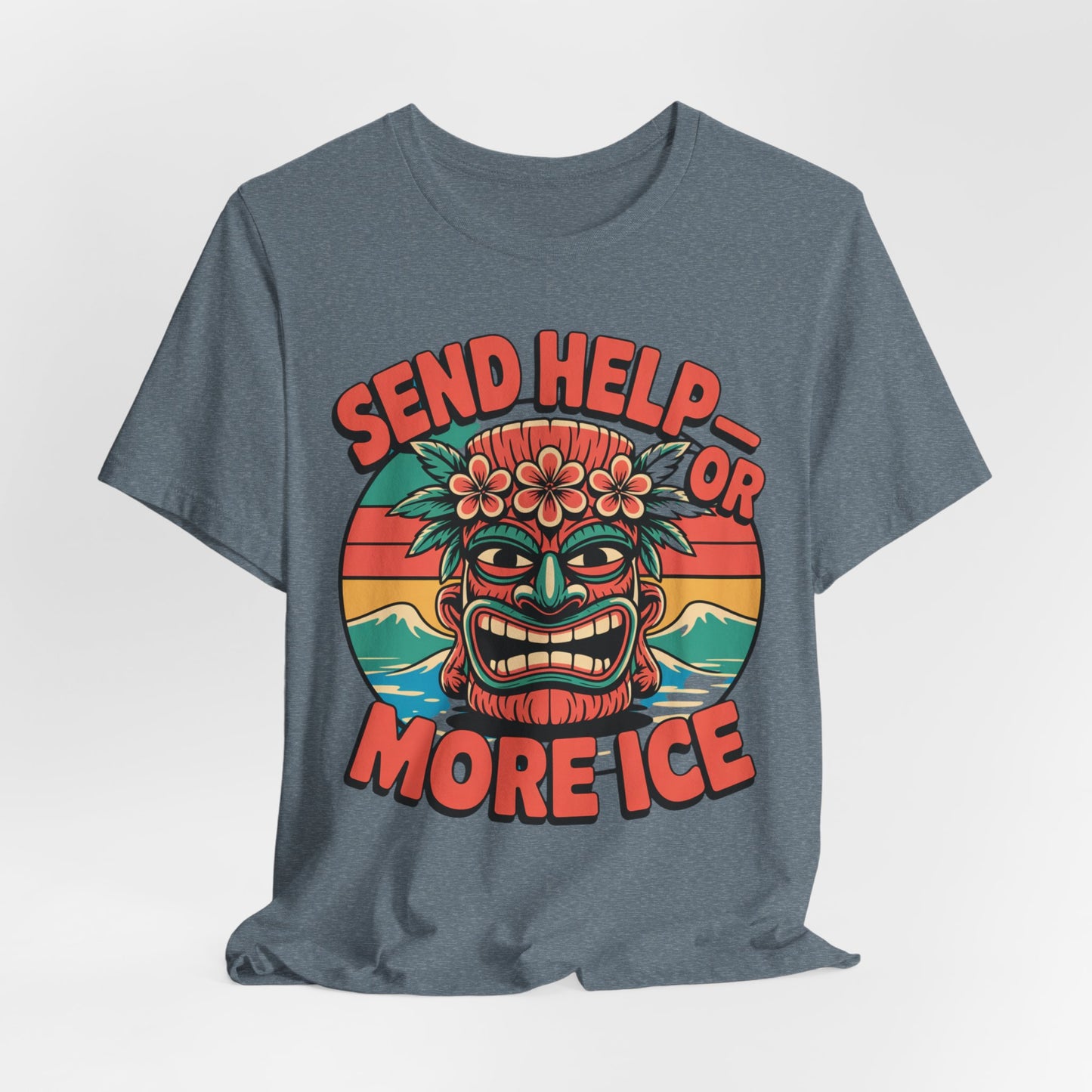 The Tropical Vibe Unisex Tiki T-Shirt - Send Help or More Ice showcases a vibrant tiki face with a flower crown, retro sunset, and waves. Bold text above and below says SEND HELP—OR MORE ICE, making it perfect for summer festivals.