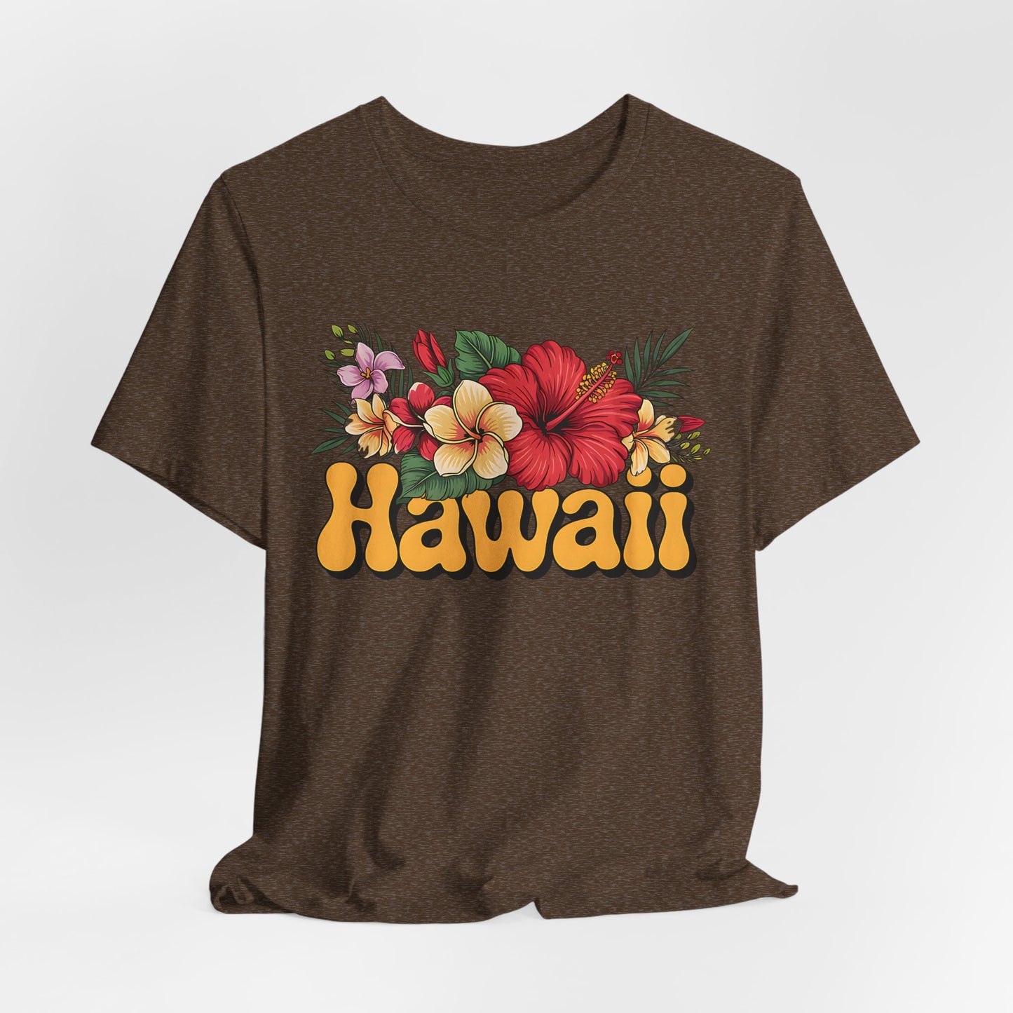 The Hawaiian Floral Unisex Tee features a colorful tropical floral design and bold Hawaii text on soft Airlume cotton, combining beach vibes and island spirit in a comfortable brown shirt for all.