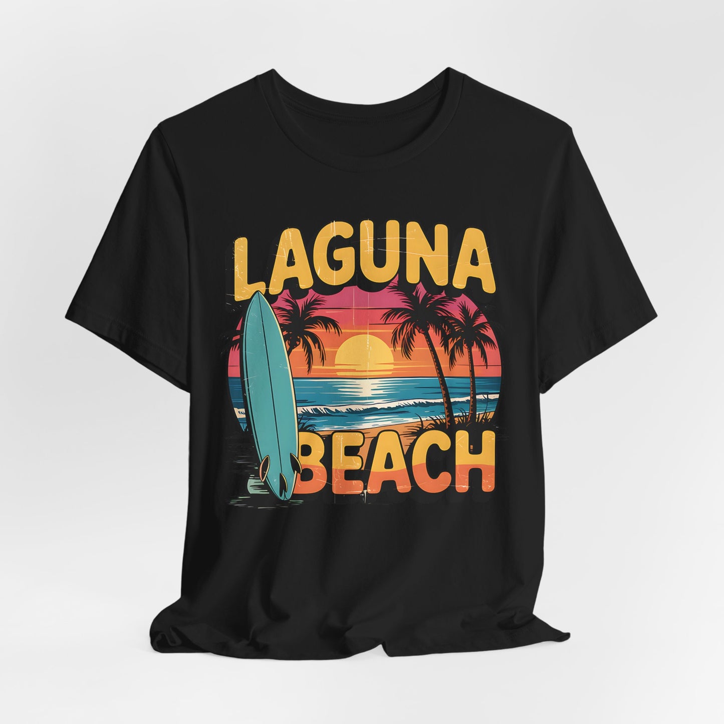 The unisex Laguna Beach Sunset Surf Tee is a relaxed fit jersey with bold yellow “Laguna Beach” lettering, sunset, ocean waves, palm trees, and a surfboard—ideal for beach lovers.