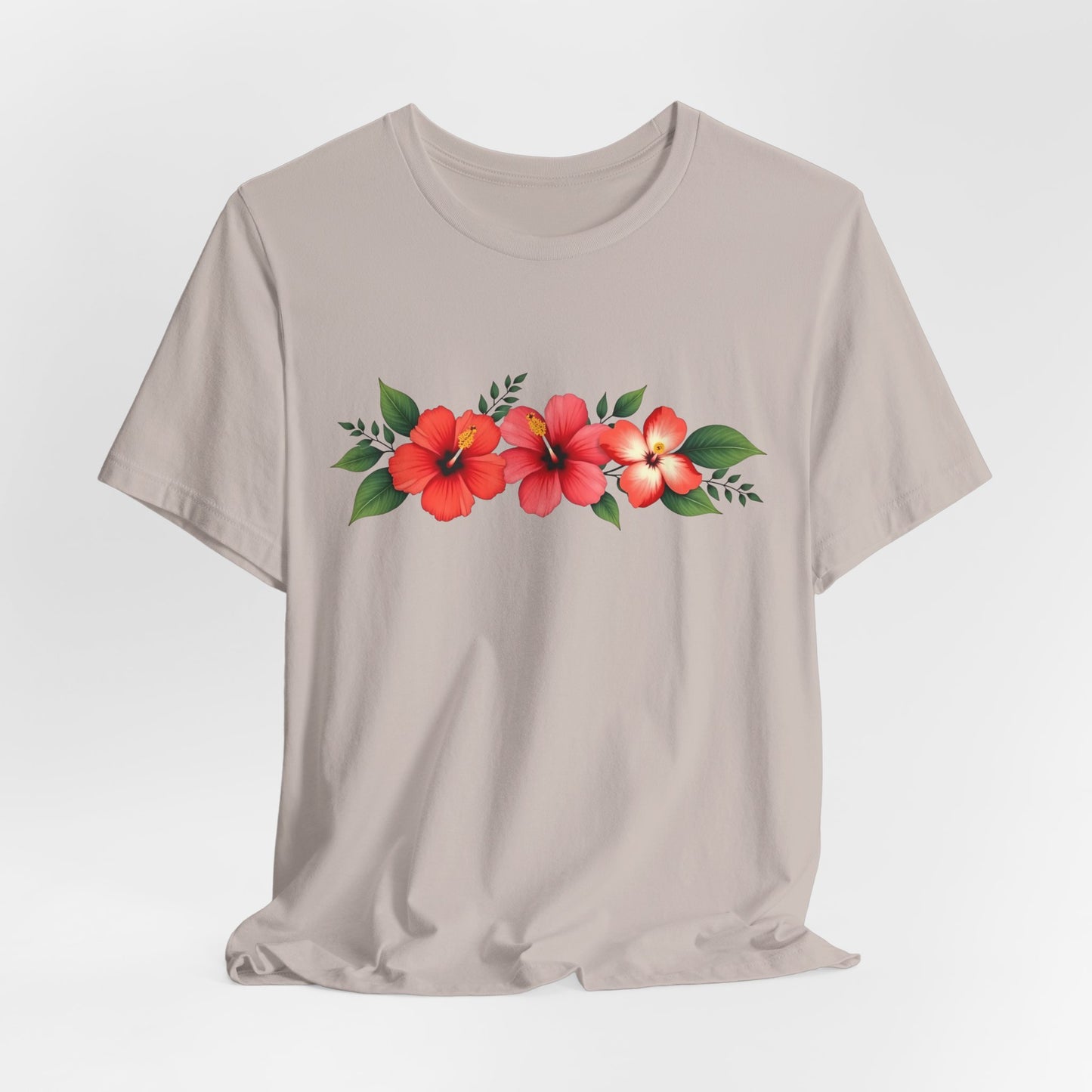 The Floral Unisex Short Sleeve T-Shirt—Perfect for Spring and Summer—is made from 100% Airlume cotton in light beige, with a row of red hibiscus flowers and green leaves printed across the chest. Ideal for casual outings.
