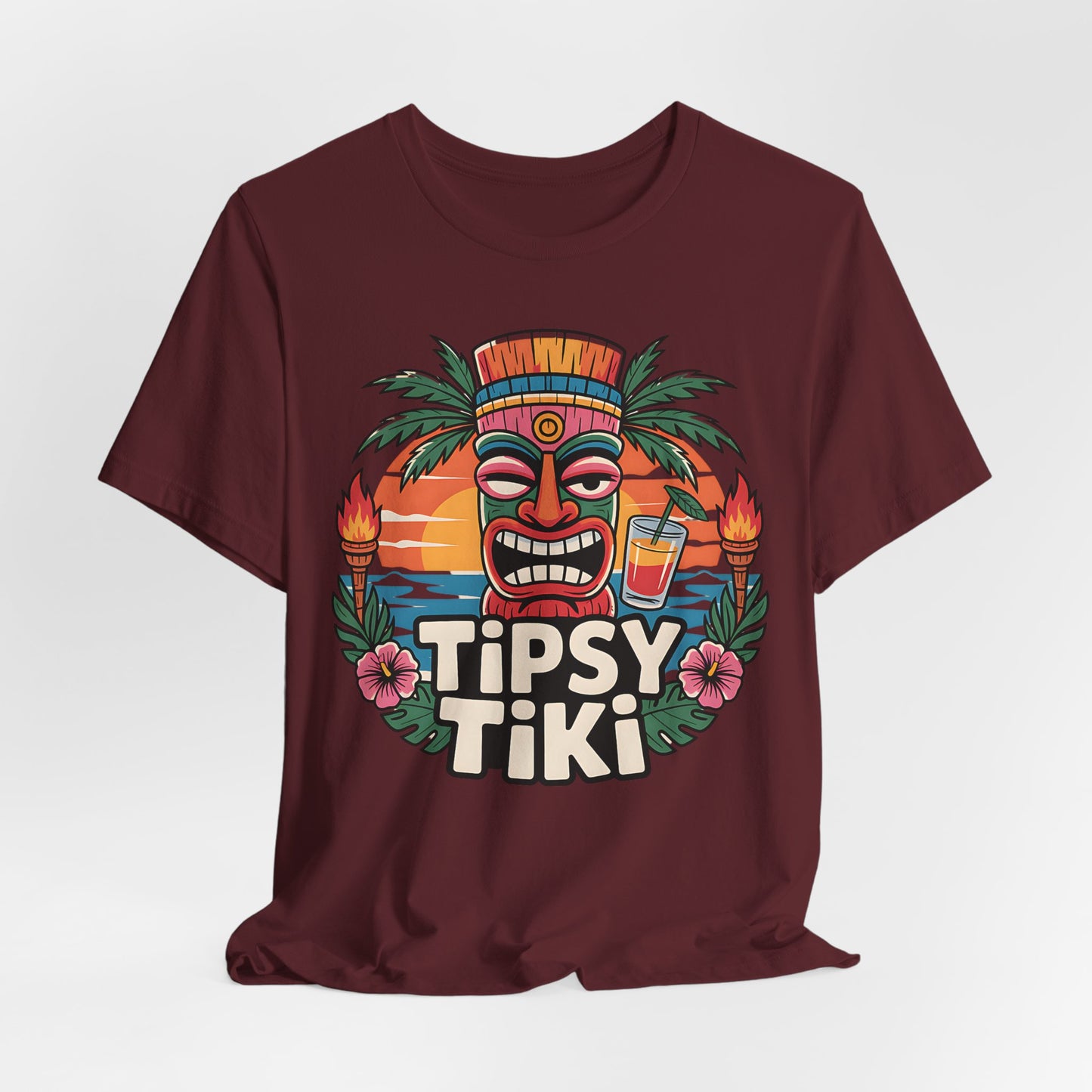 Maroon t-shirt with 'Tipsy Tiki' design featuring a tiki mask and tropical elements on a white background.