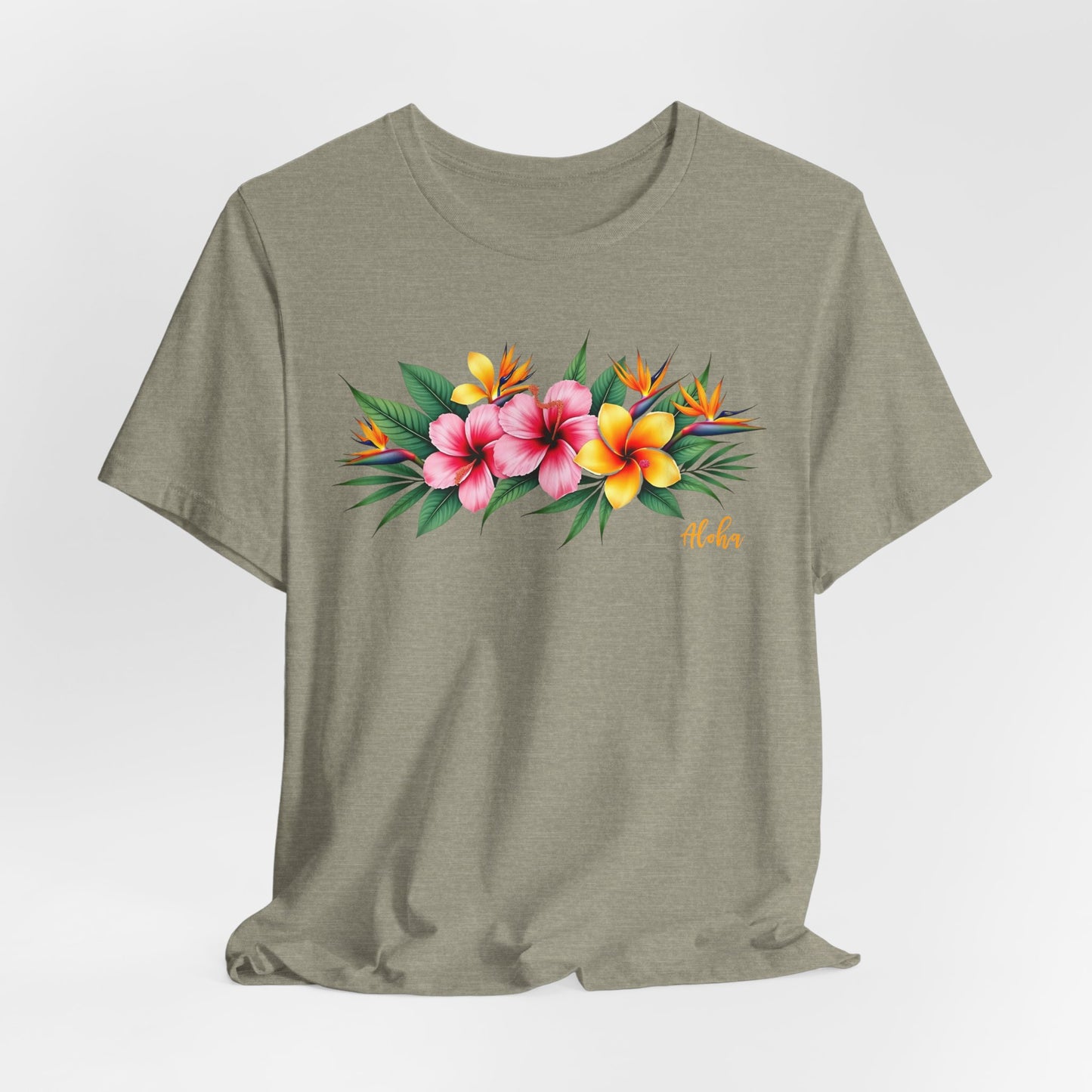 The Tropical Floral Unisex Jersey T-Shirt is perfect for summer, featuring pink, yellow, and orange tropical flowers with green leaves and “Aloha” script. Made from soft Airlume combed cotton for comfort and style.