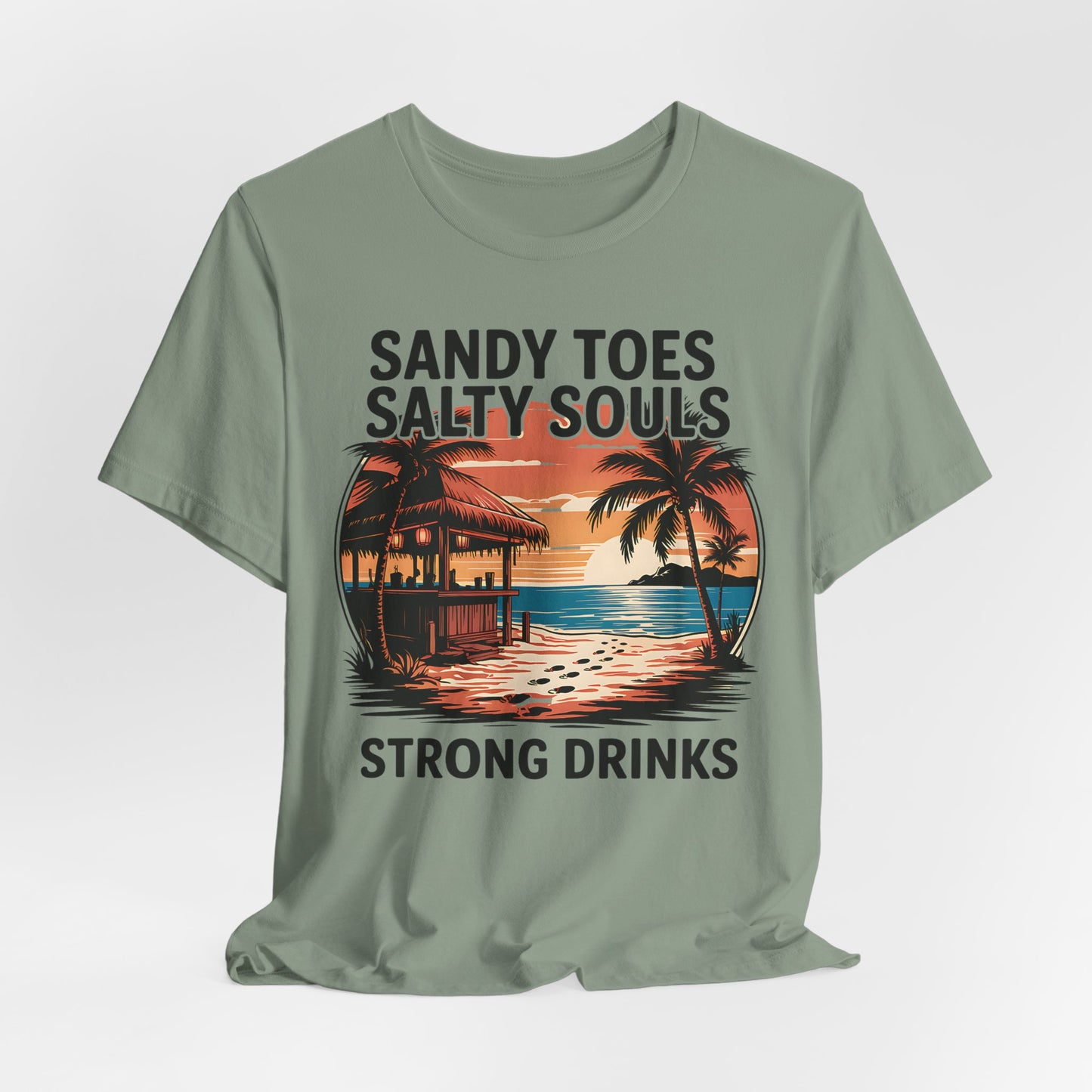 The Sandy Toes Salty Souls Tee - Unisex Jersey Short Sleeve for Beach Lovers is light green with a tropical sunset, palm trees, and a hut. “Sandy toes, salty souls, strong drinks” frames the image. Made from soft Airlume combed cotton.