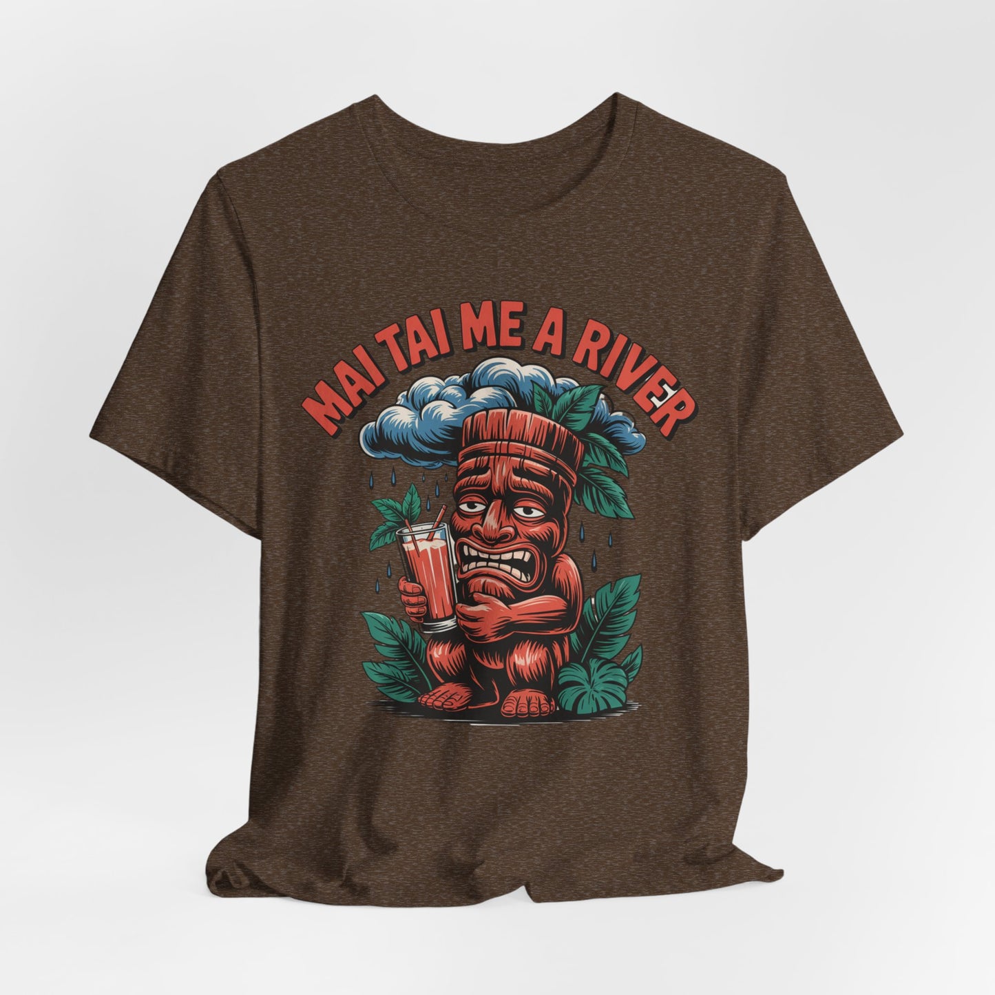 The Mai Tai Me a River Tropical Tiki T-Shirt features a cartoon tiki with Mai Tais and a tear, tropical leaves, and MAI TAI ME A RIVER above—perfect for bold, unique style lovers.