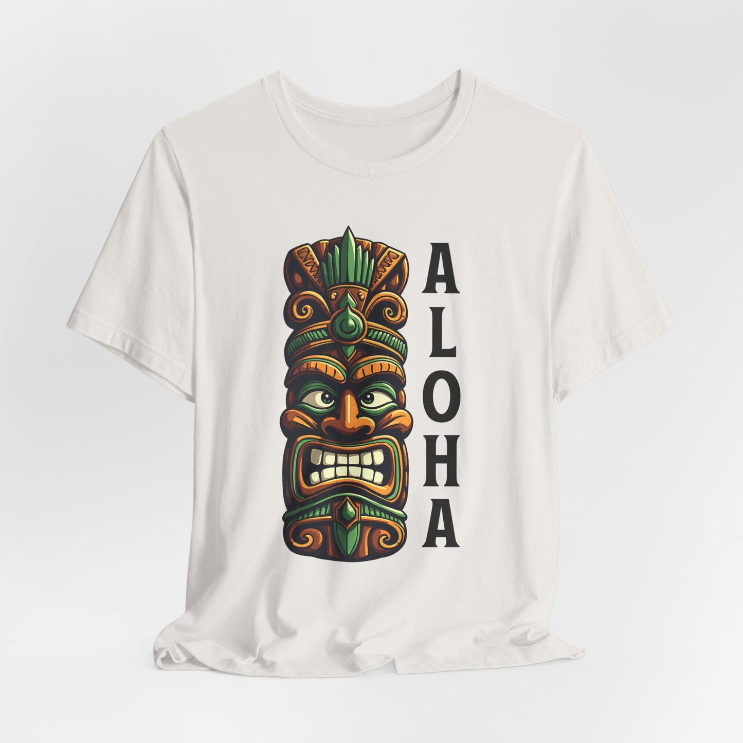 The Aloha Tiki- Graphic Tiki T-Shirt for Beach Lovers is a white unisex short sleeve tee with a colorful tiki mask and bold “ALOHA”—ideal for anyone dreaming of a tropical paradise.