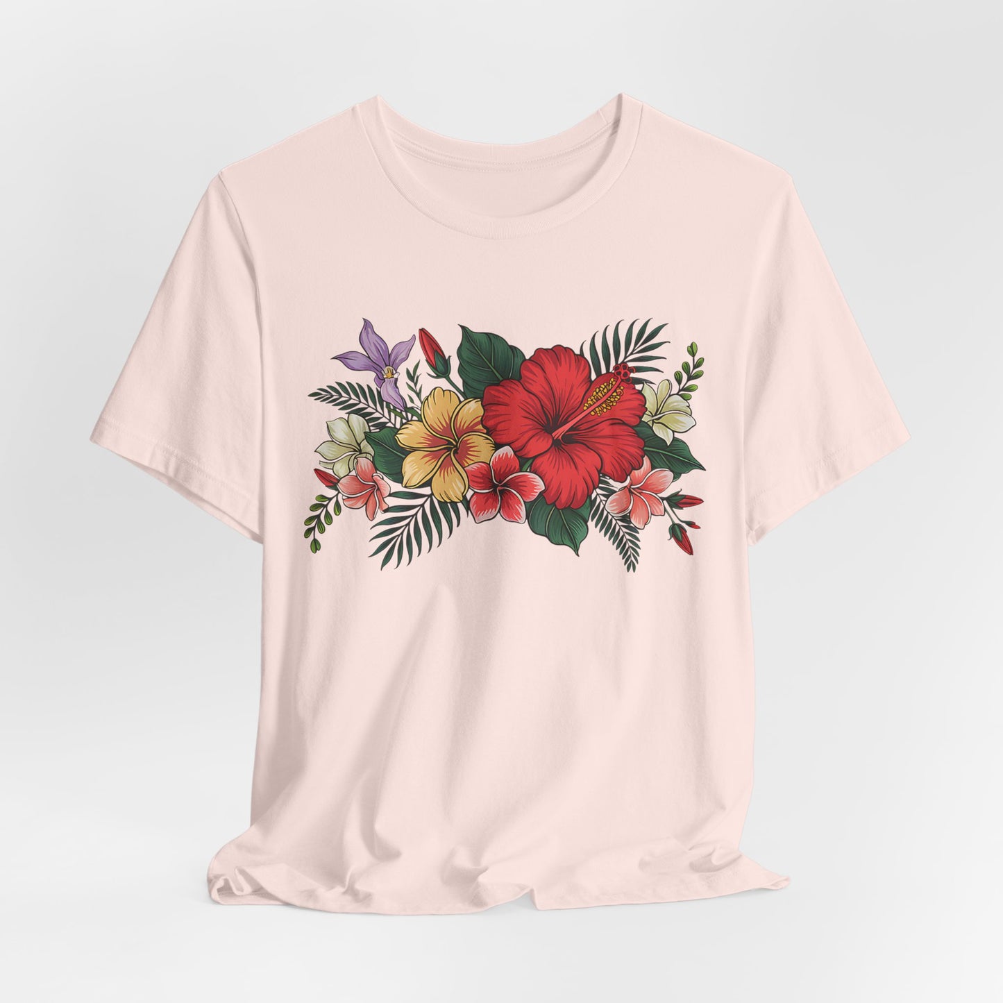 The Tropical Floral Unisex T-Shirt - Vibrant Summer Style is a light beige tee made from soft Airlume cotton, featuring a colorful floral design with red, yellow, and purple flowers, green leaves, and red berries across the chest.