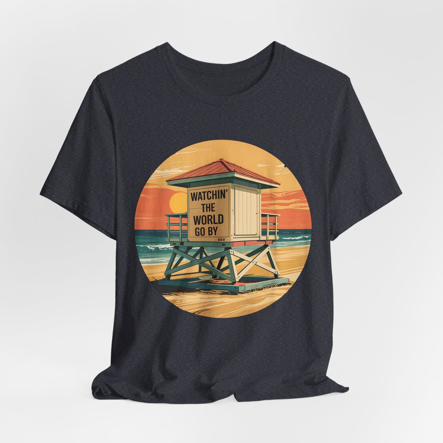 The Watchin The World Go By T-Shirt is a unisex jersey short sleeve shirt for beach lovers, featuring an illustrated lifeguard tower at sunset with WATCHIN THE WORLD GO BY—perfect for summer vacations.