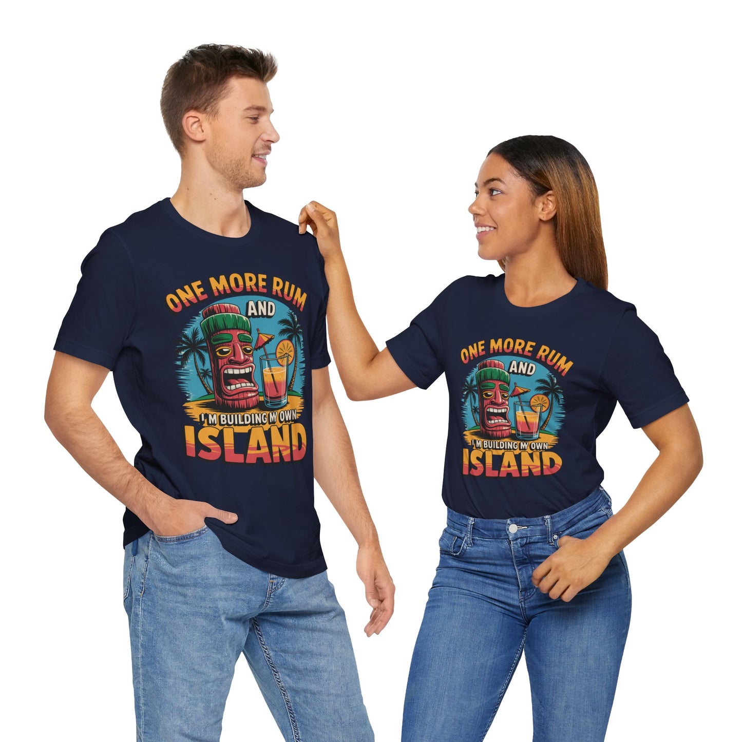 A smiling couple wears matching Tropical Vacation Tiki T-Shirts—One More Rum and Im Building My Own Island—featuring a colorful tiki drink, palm trees, and sunset graphic, in lightweight fabric perfect for beach lovers.