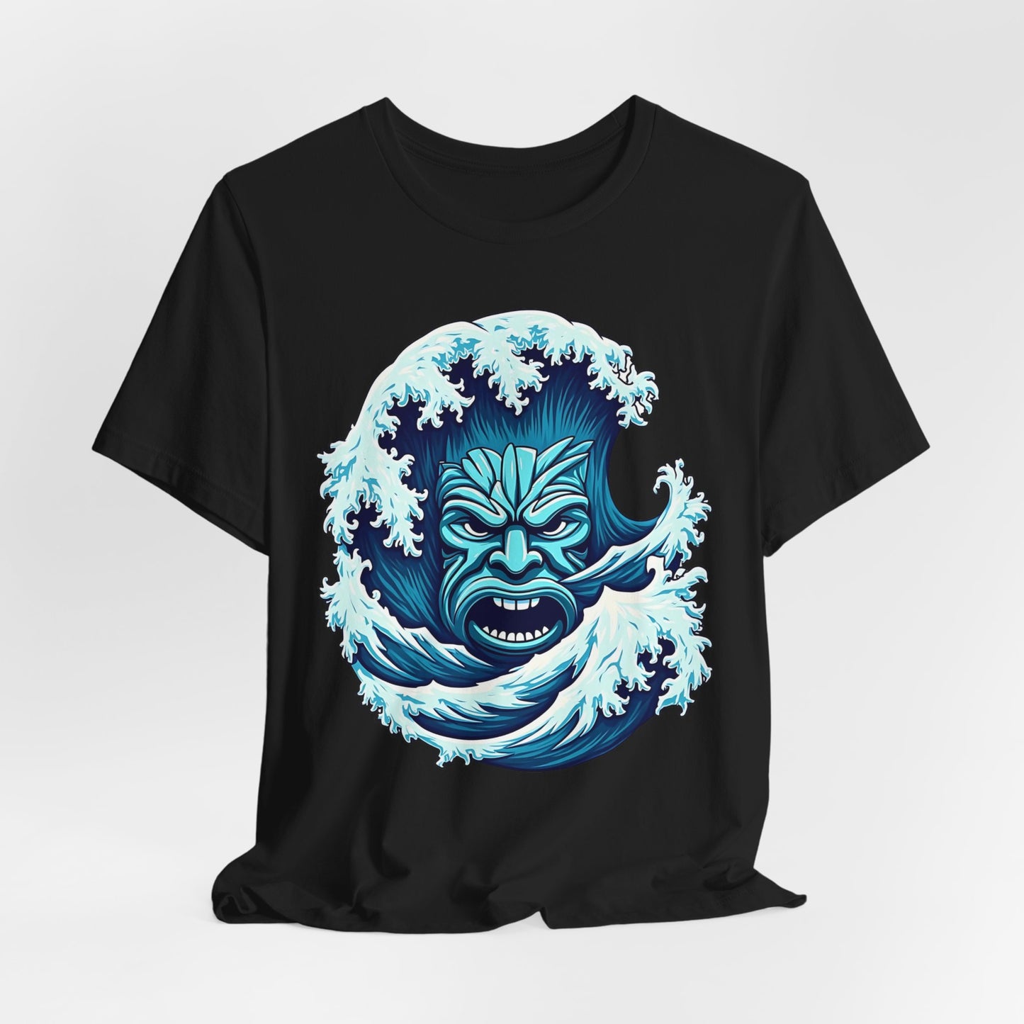 The Ocean Wave Tiki- Adventure Vibes unisex black jersey t-shirt features soft Airlume cotton and a bold blue-and-white graphic of ocean waves forming a fierce tiki mask—ideal for beach lovers.