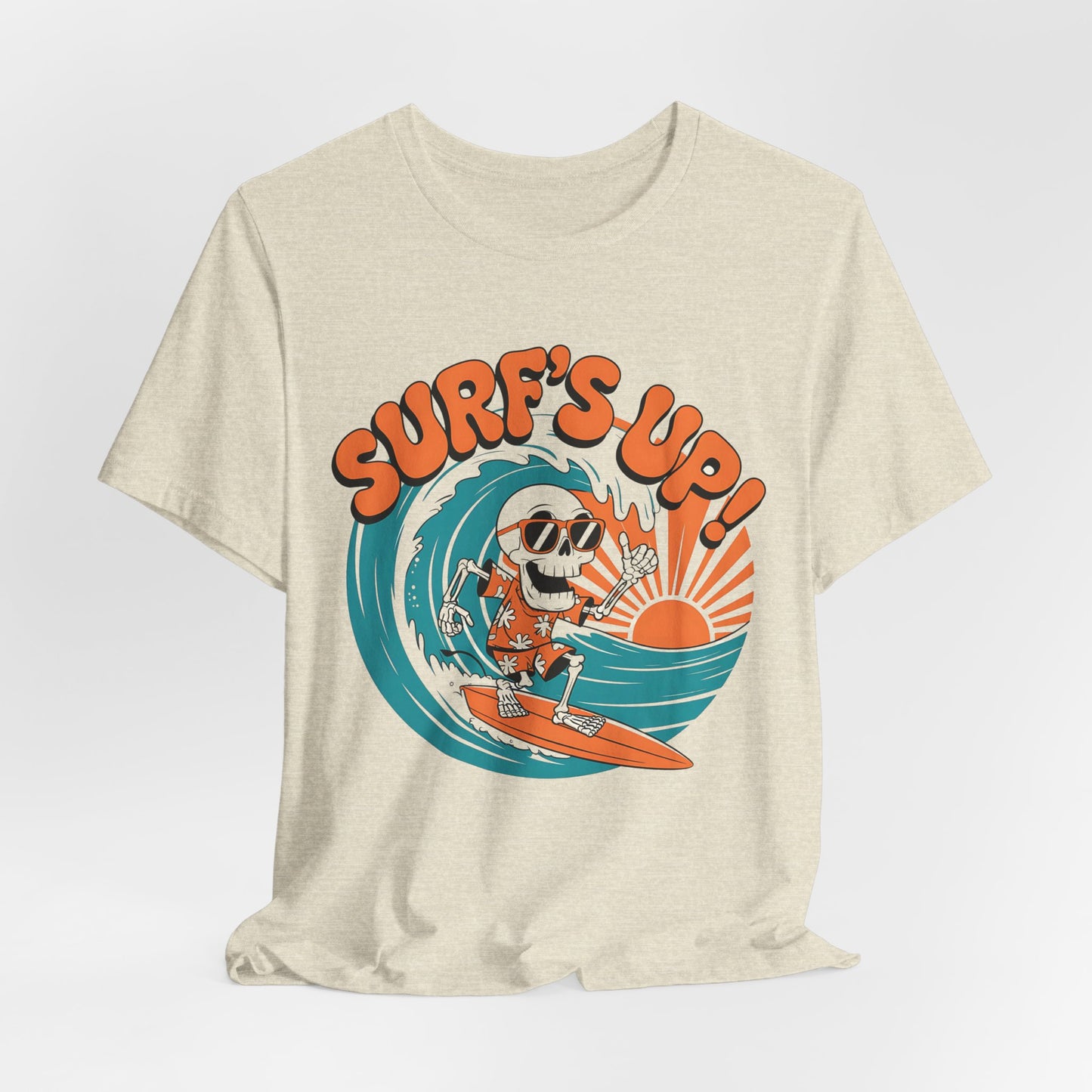 The Surfs Up Skeleton Unisex Jersey Tee features a cartoon skeleton surfing in sunglasses and a floral shirt, with an orange sun and SURFS UP!—a fun beach vibe t-shirt, perfect for summer outings or vacations.