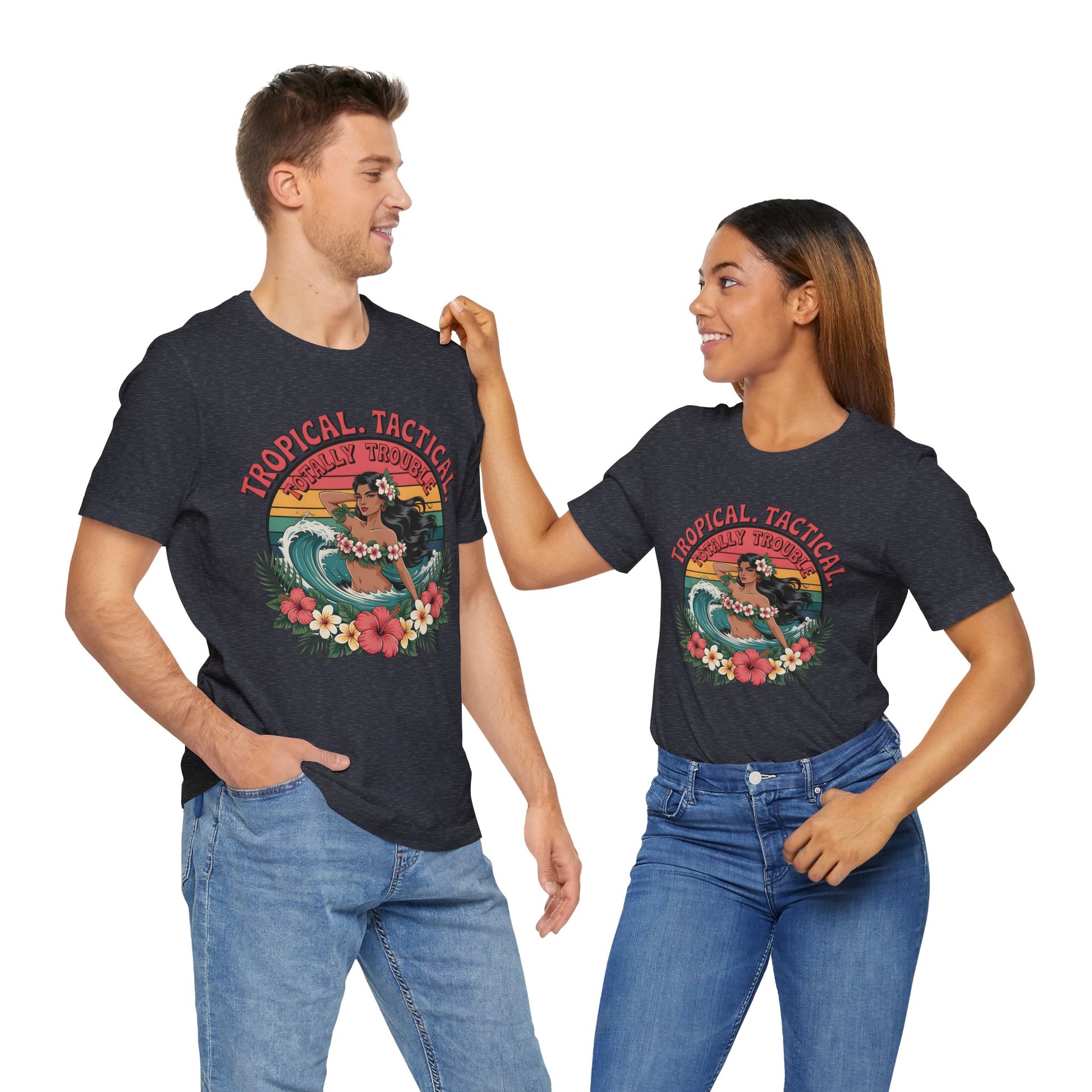 A man and woman smile at each other, both wearing Tropical Tactical Unisex Jersey T-Shirts—Aloha Vibes & Summer Fun—featuring a vibrant beach scene with palm trees and flowers as they pose with hands in their jeans pockets.