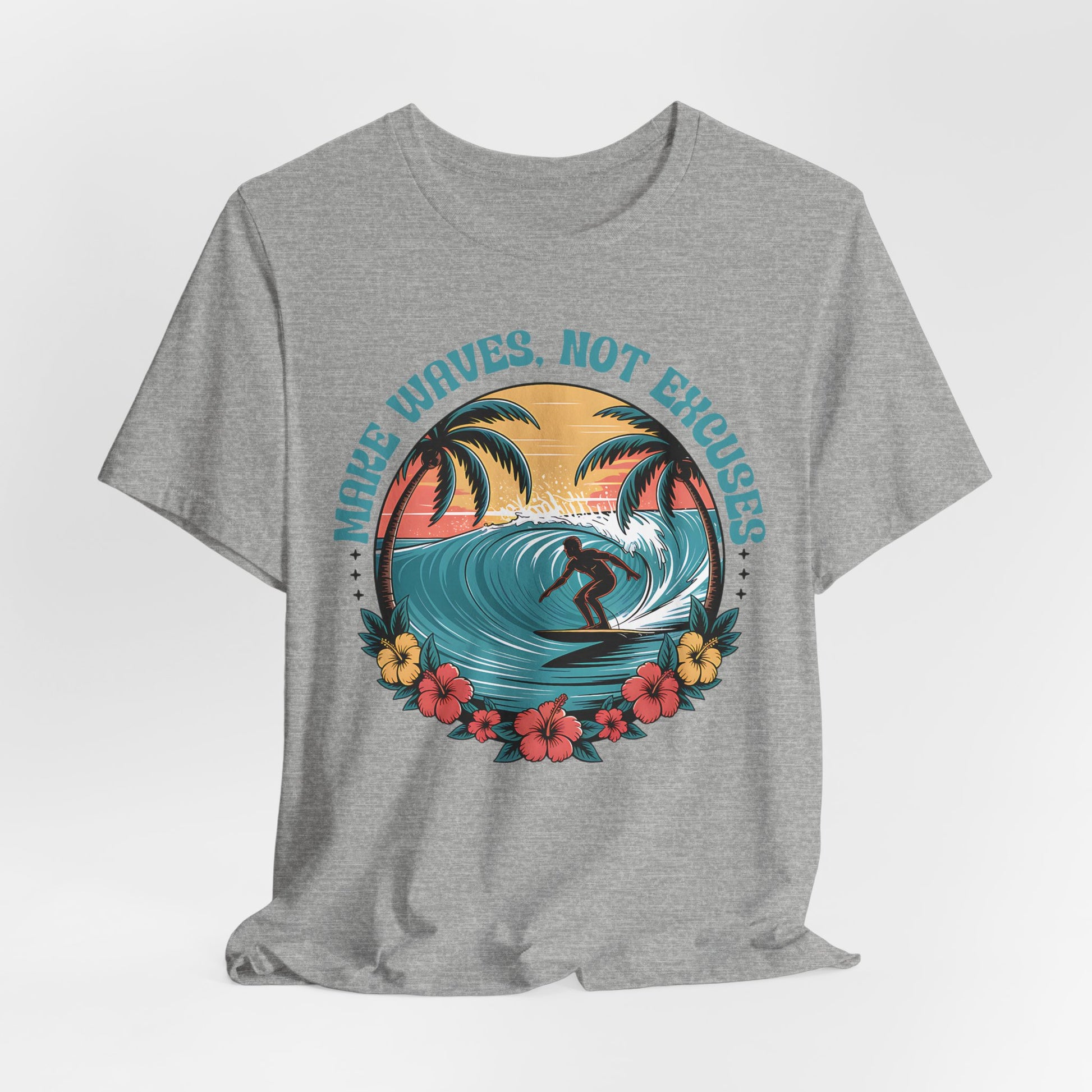 The Surf Tee - Make Waves Not Excuses - Inspirational T-Shirt is a gray shirt with a surfer on a wave, palm trees, flowers, and a sunset. The phrase “MAKE WAVES, NOT EXCUSES” appears above—great for surfing or beach trips.