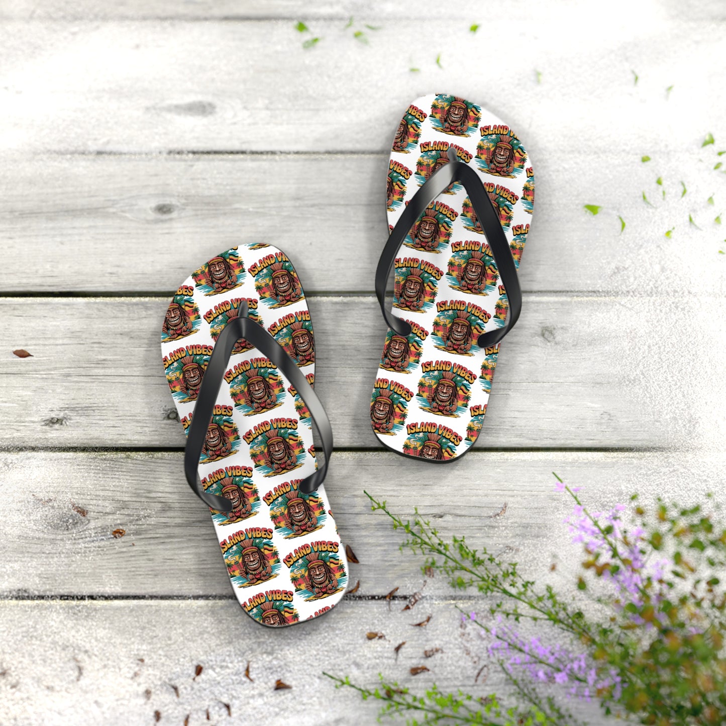 Island Vibes Tiki Flip Flops – Colorful Casual Footwear for Summer Fun—with vibrant tiki face designs and “Island Vibes” text, shown on a light wooden surface with green foliage. Perfect for beach lovers and summer getaways.