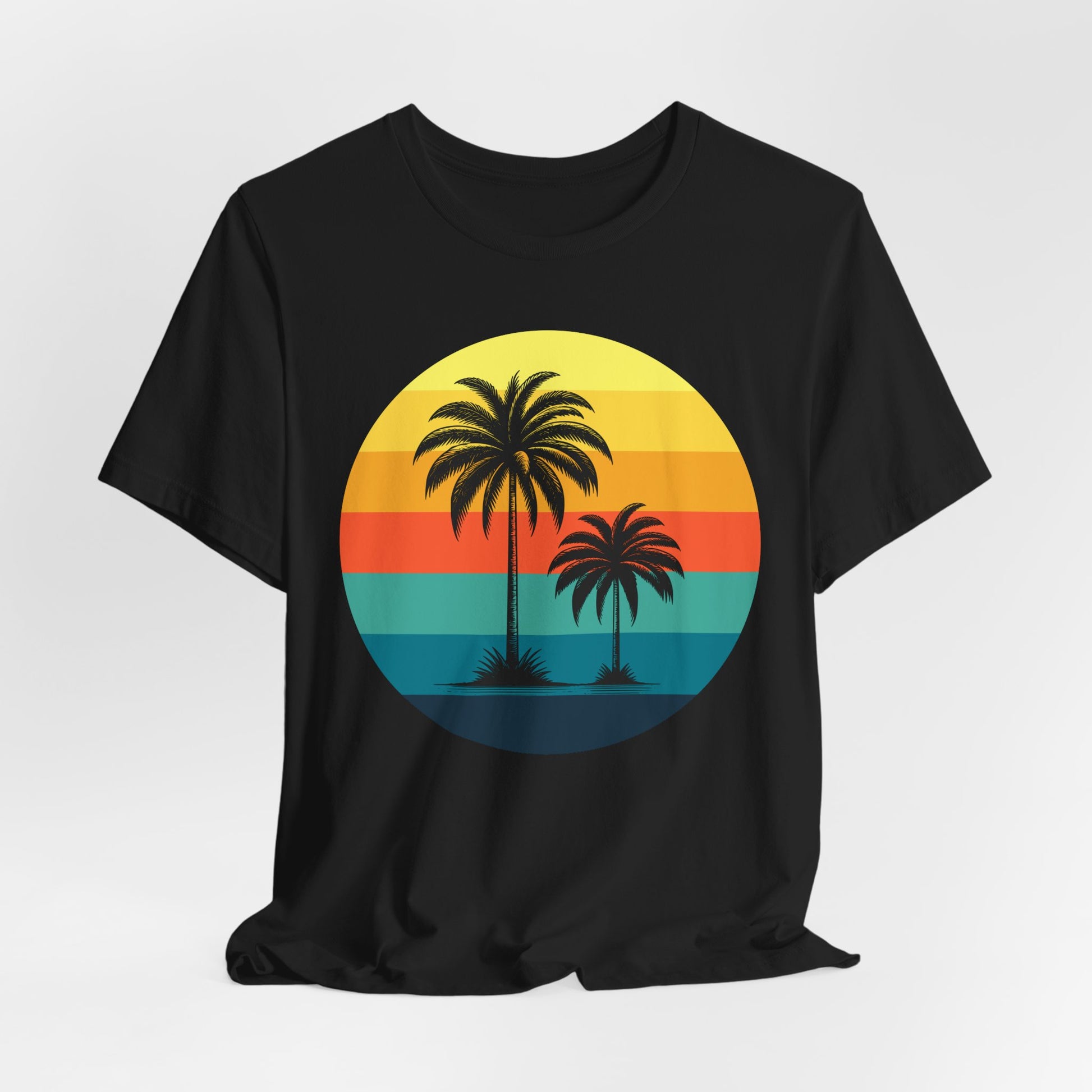 The Sunset Palm Trees Unisex Jersey T-Shirt - Vibrant Beach Vibe features a black tee with a circular graphic of two palm trees over a retro striped sunset in yellow, orange, red, and teal—ideal for summer holidays and tropical events.