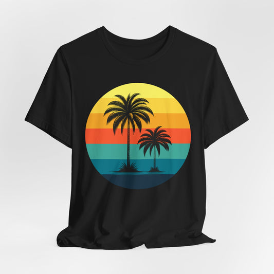 The Sunset Palm Trees Unisex Jersey T-Shirt - Vibrant Beach Vibe features a black tee with a circular graphic of two palm trees over a retro striped sunset in yellow, orange, red, and teal—ideal for summer holidays and tropical events.