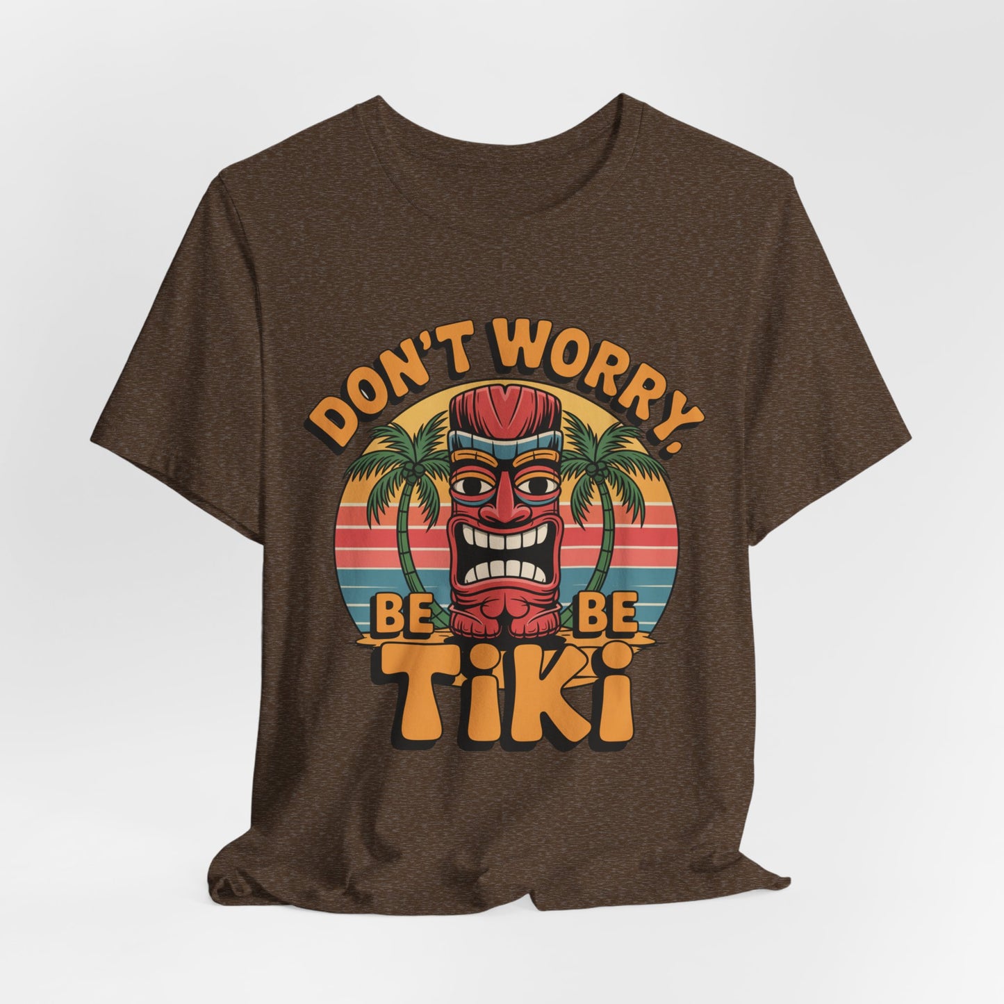 Bring island vibes to your look with the Tiki Vibes Unisex Jersey Tiki T-Shirt, featuring a bold tiki mask, palm trees, sunset stripes, and the “Dont Worry, Be Tiki” slogan in vibrant style.