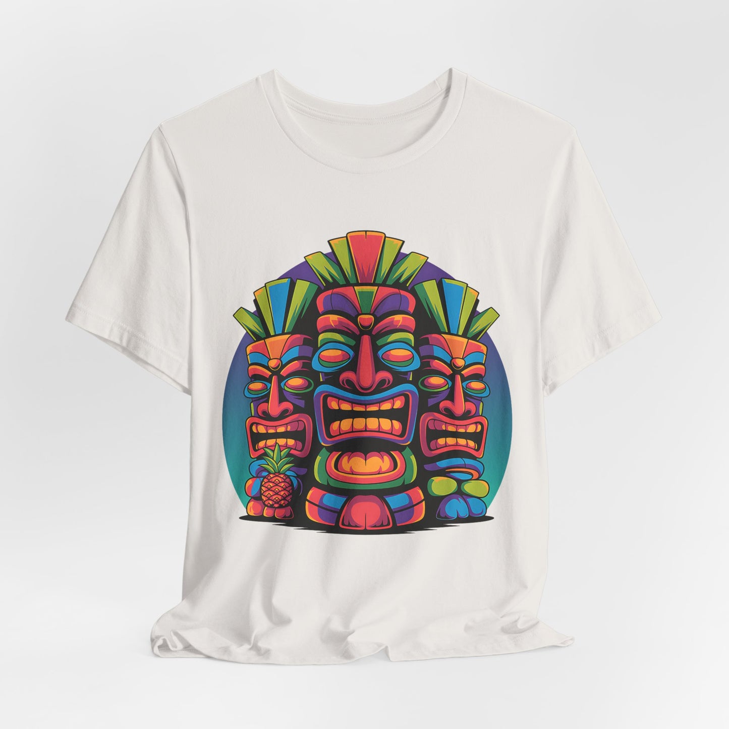 The Vibrant Tribal Mask Tiki T-Shirt - Unisex Short Sleeve showcases three stylized tiki masks with a pineapple, making it a lively addition to your casual wardrobe.