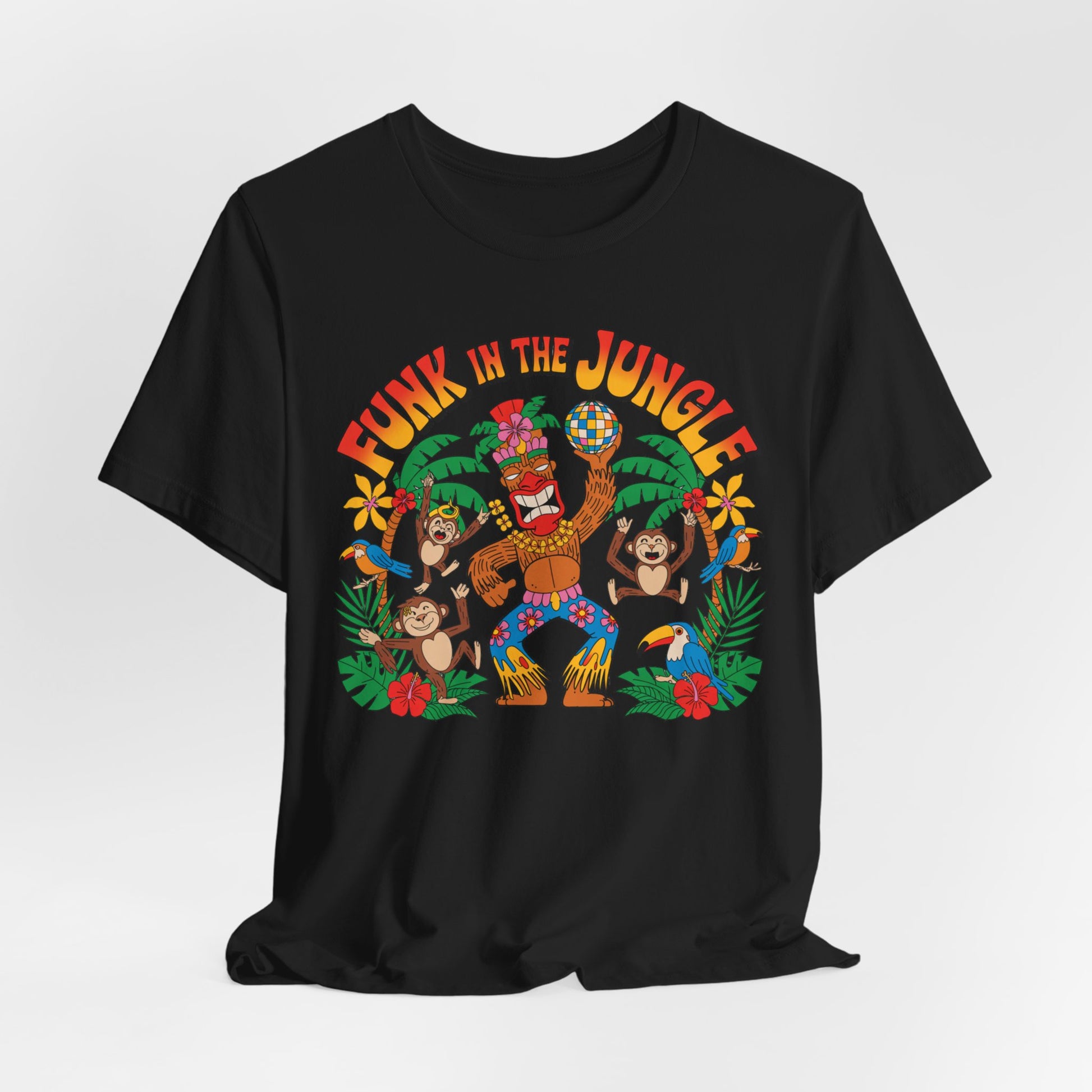 The Funky Jungle Tiki T-Shirt is a black unisex short sleeve shirt with a vibrant cartoon of a dancing gorilla under a disco ball, two monkeys, jungle leaves, red flowers, and bold orange FUNK IN THE JUNGLE text.
