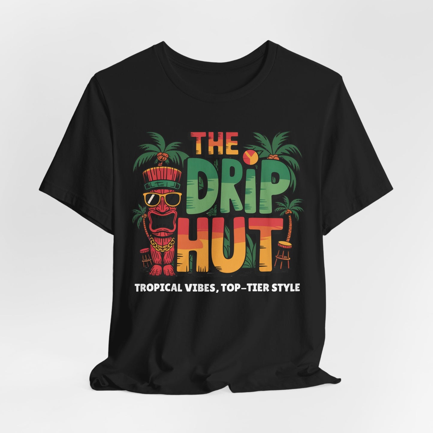The Tropical Vibes Unisex Tiki T-Shirt - The Drip Hut features a vibrant island design with The Drip Hut above Tropical Vibes, plus a tiki mask, palm trees, cocktail, and sun for festive style.
