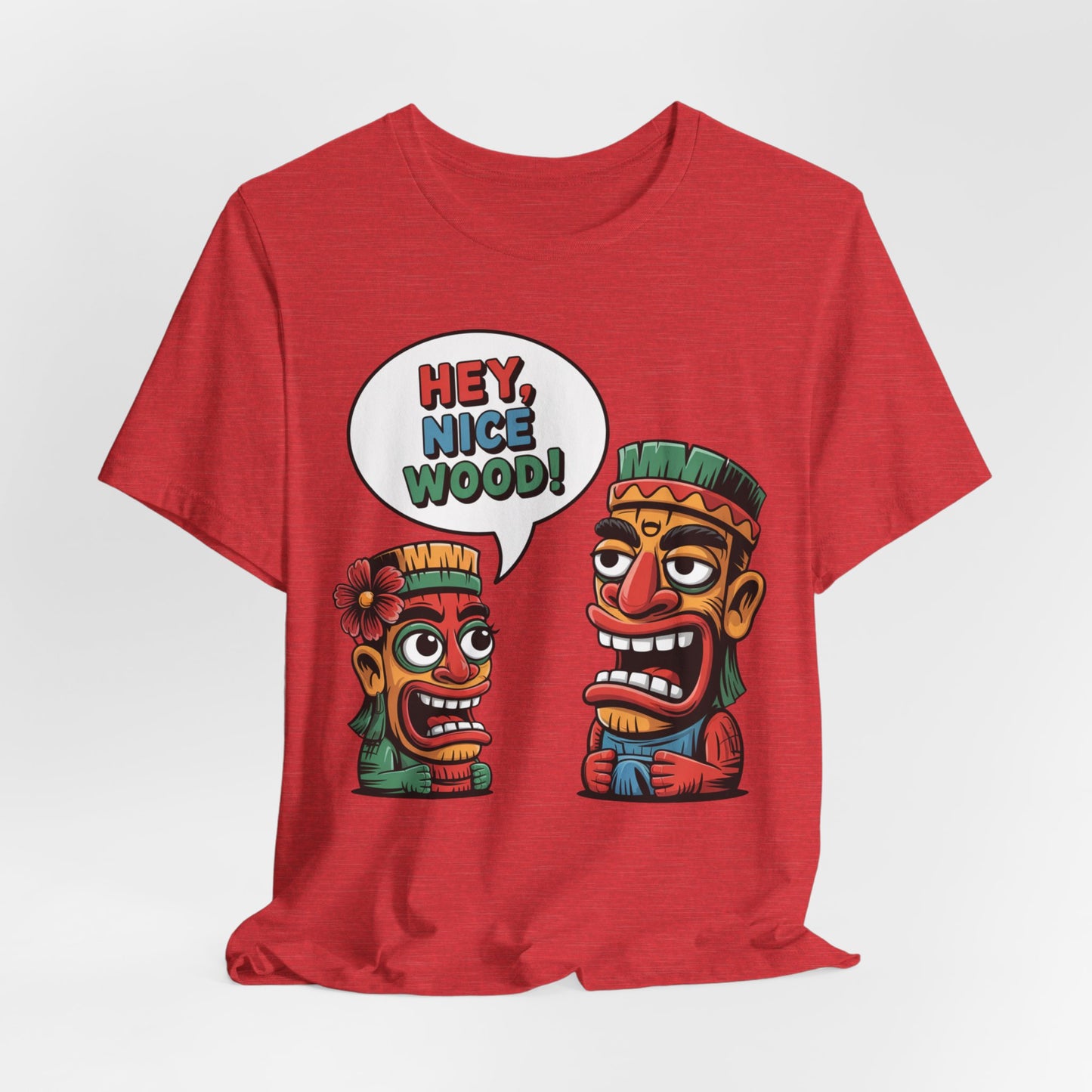 The Tropical Humor Short Sleeve Tiki T-Shirt – Hey, Nice Wood! features two cartoon tiki faces: a larger tiki and a surprised, flower-wearing smaller one. This breathable unisex jersey comes in vibrant colors.