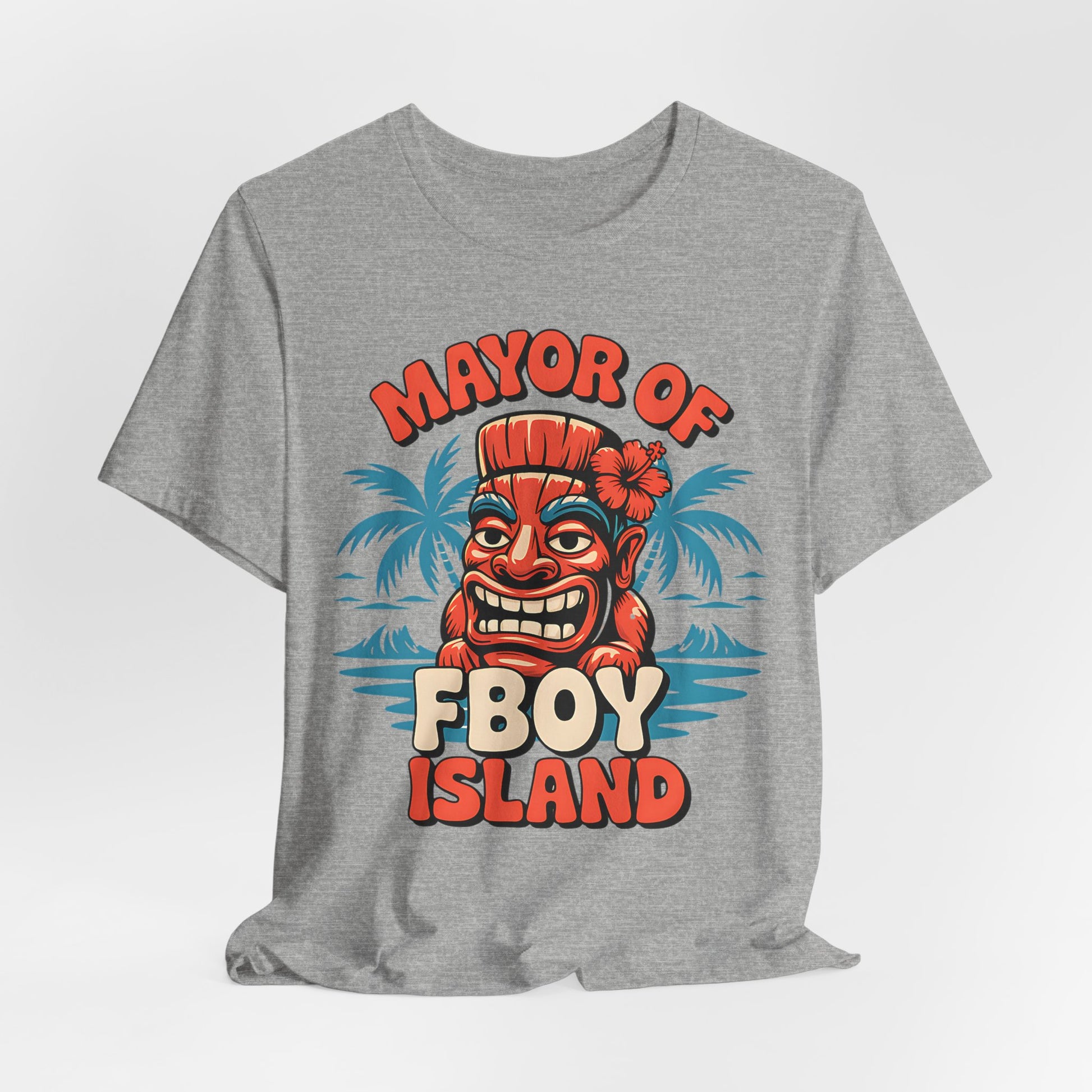The Mayor of FBOY Island Short Sleeve Tiki T-Shirt is a gray unisex tee with a vibrant cartoon Tiki head, playful spirits, palm silhouettes, and bold text. Made from 100% Airlume cotton for summer-ready comfort and fun vibes.