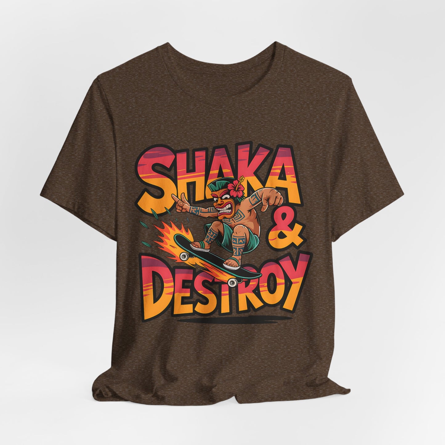The Shaka & Destroy Graphic Tiki T-Shirt is a brown unisex jersey tee for skateboard enthusiasts, featuring a bold, colorful cartoon skater with a hat, sunglasses, and flower, plus SHAKA & DESTROY lettering.
