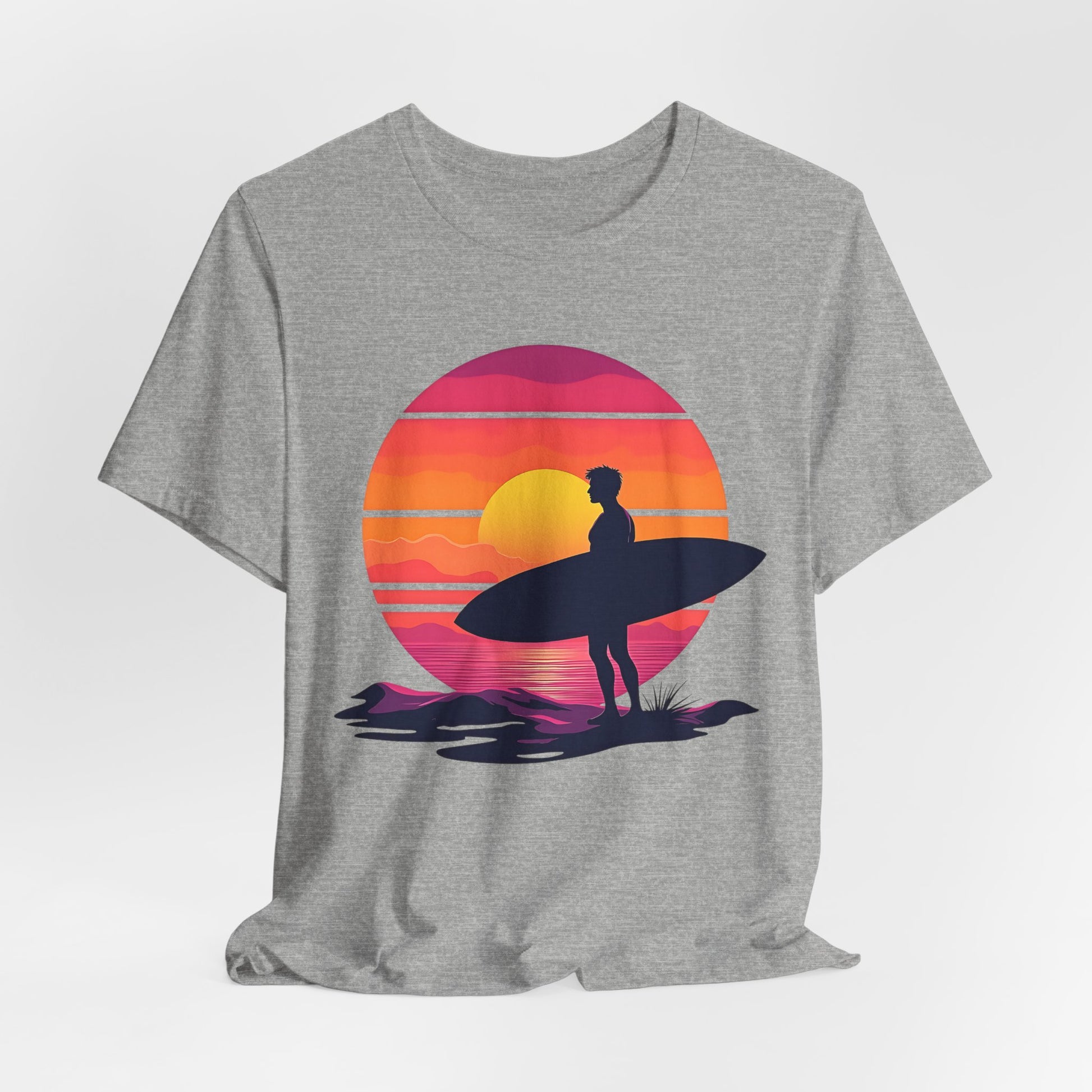 The Sunset Surfing Unisex Jersey T-Shirt features a vivid DTG-printed graphic of a surfer with a surfboard at sunset—an ideal choice for beach lovers.