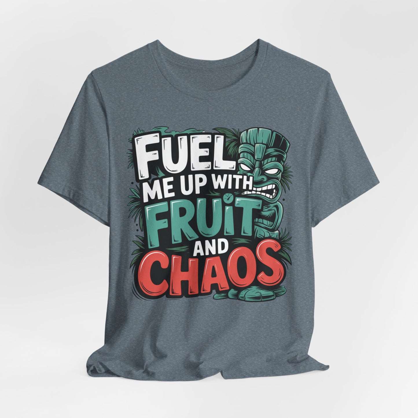 The Fuel Me Up With Fruit and Chaos Unisex Jersey Tiki T-Shirt is a gray tee with bold, colorful text and a green tiki face—perfect for summer adventures and adding playful style to your wardrobe.