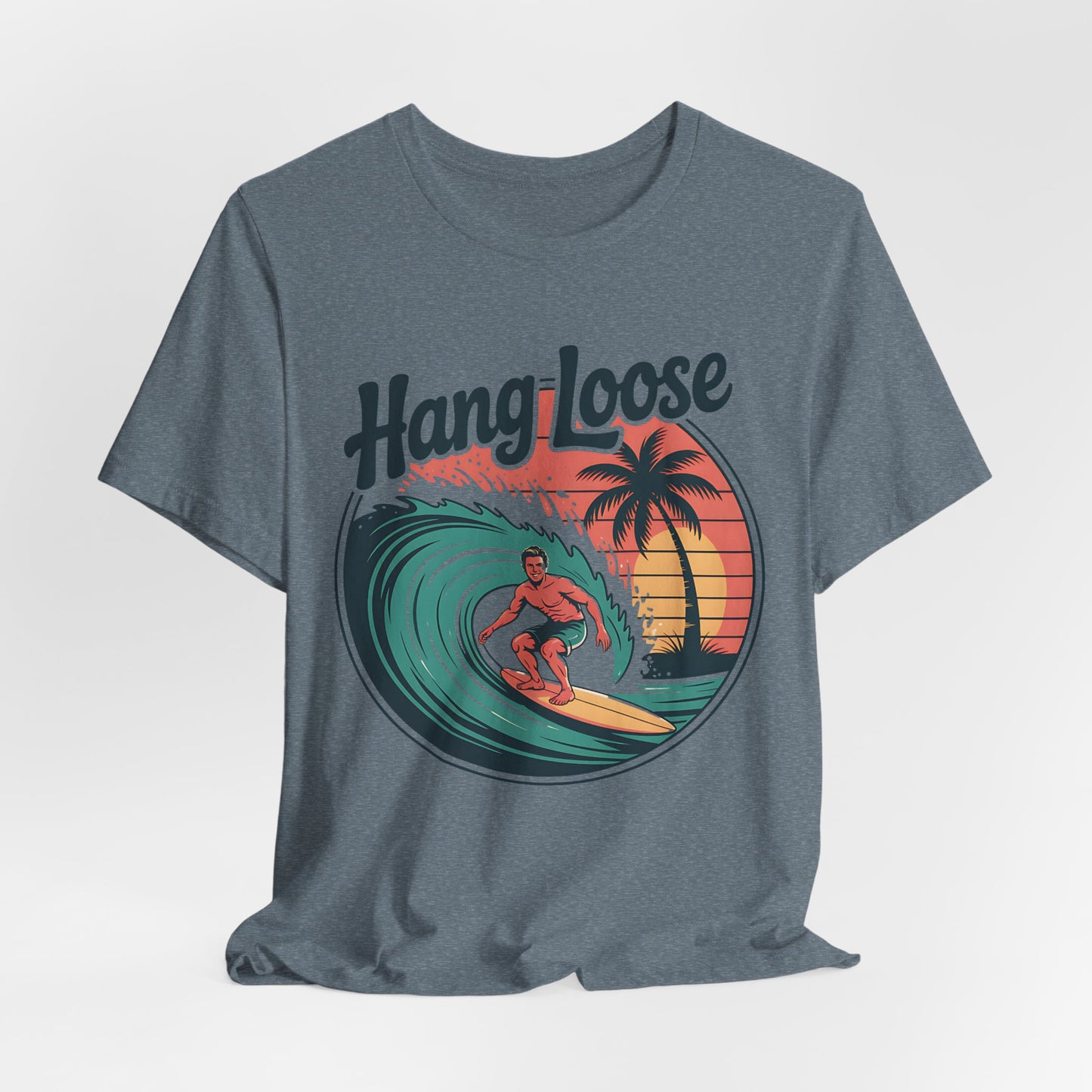 The Hang Loose Unisex Surf T-Shirt features a retro beach vibe with a graphic of a surfer, palm trees, and sunset. Made from soft Airlume cotton, it captures carefree style with Hang Loose above the design.
