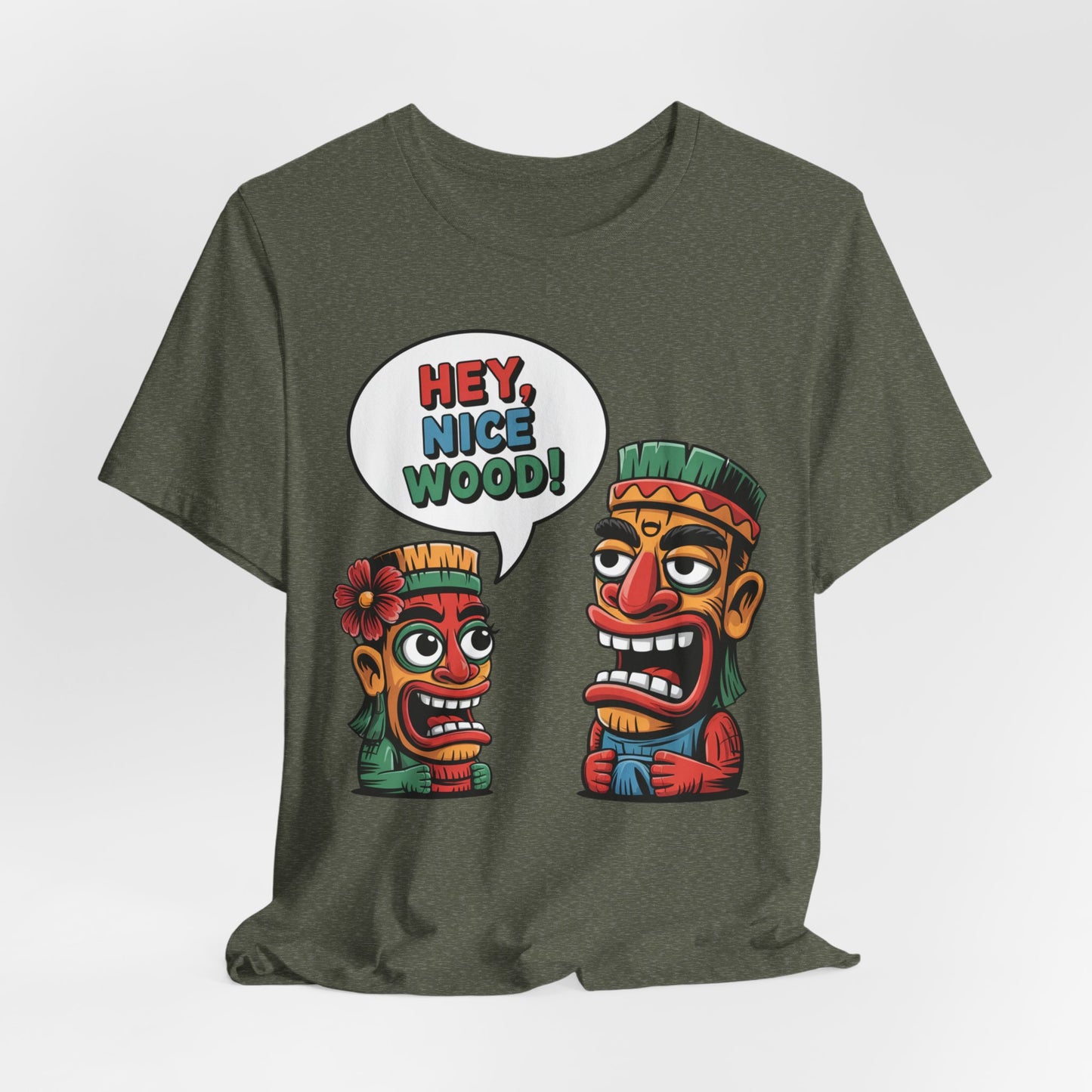 The Tropical Humor Short Sleeve Tiki T-Shirt - Hey, Nice Wood! Graphic is a green unisex tee featuring two vibrant cartoon tiki faces, one with a speech bubble saying HEY, NICE WOOD! for a fun, playful look.
