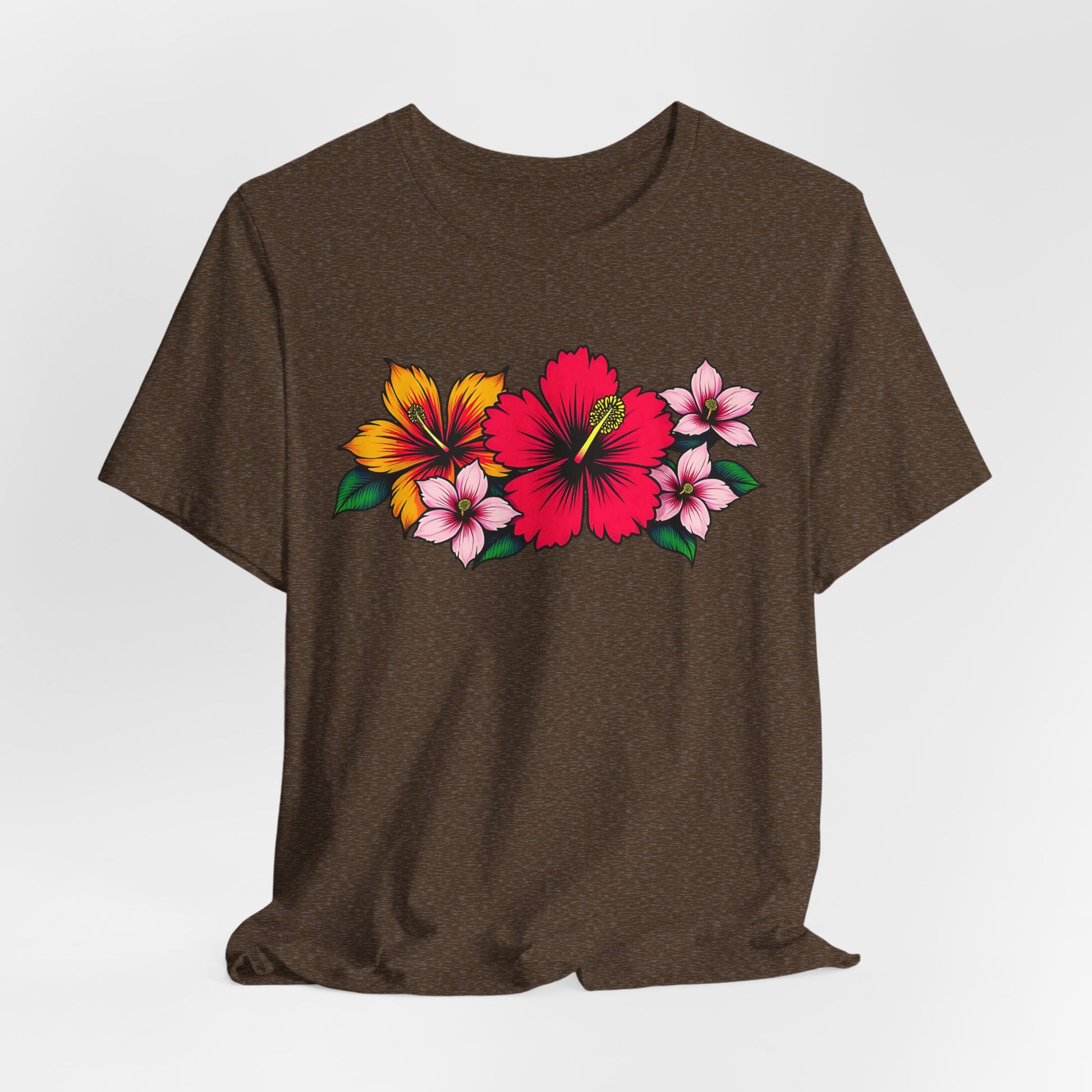 The Tropical Floral Unisex Jersey T-Shirt boasts vibrant floral designs with a standout red hibiscus, plus yellow and pink flowers with green leaves—ideal for summer and beach days.