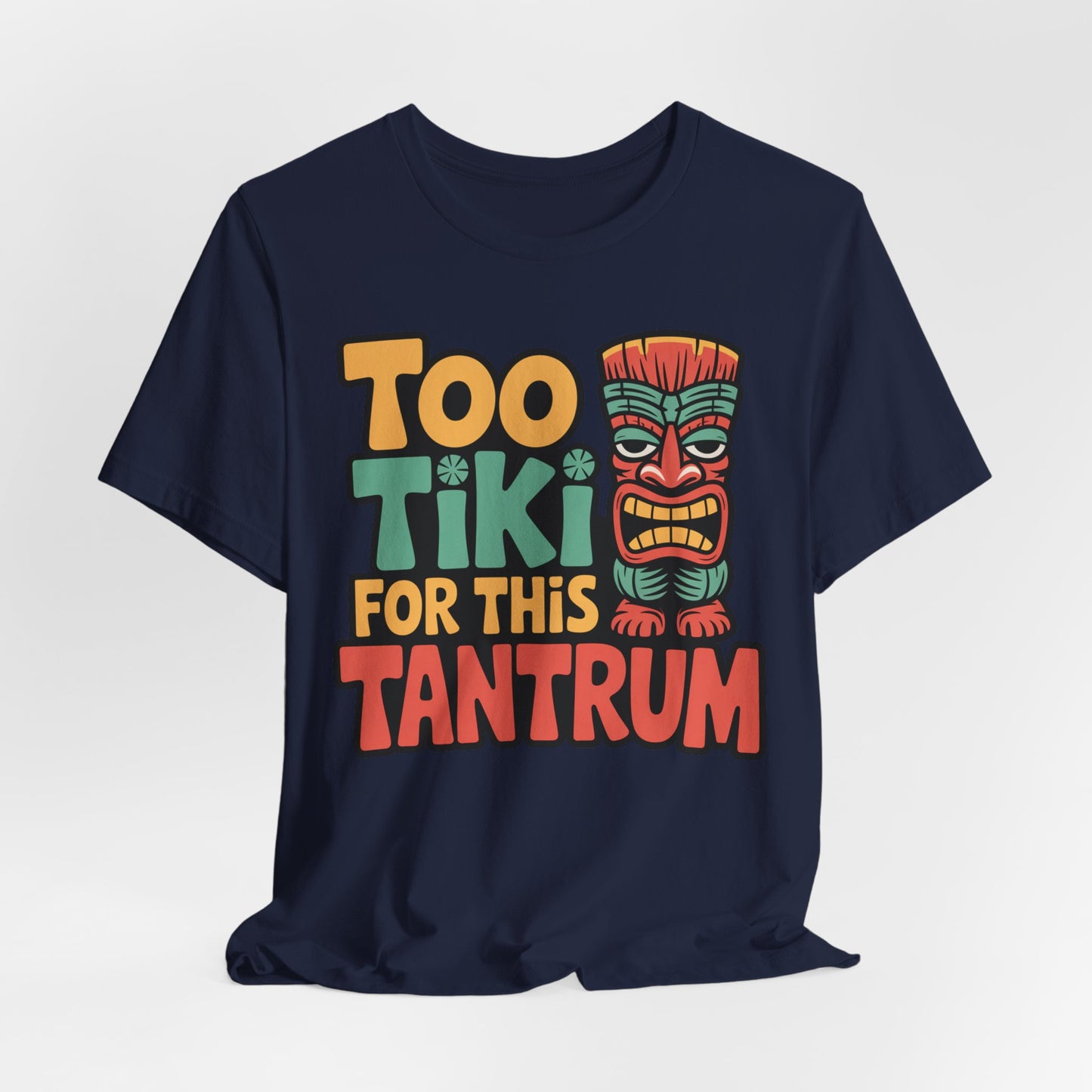 The Tiki Tantrum T-Shirt is a unisex navy blue jersey tee featuring colorful “Too Tiki For This Tantrum” text and a playful tiki face, made from breathable fabric—perfect for tropical vibes and celebrations.