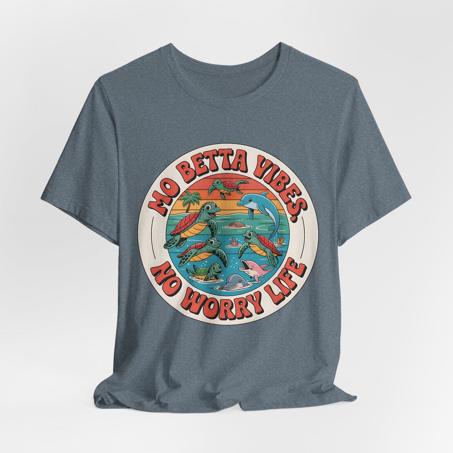 The Mo Betta Vibes Unisex Jersey T-Shirt features a relaxed fit, a vibrant circular ocean graphic with turtles and dolphins, and the uplifting message MO BETTA VIBES, NO WORRY LIFE—perfect for adding positivity to your summer style.
