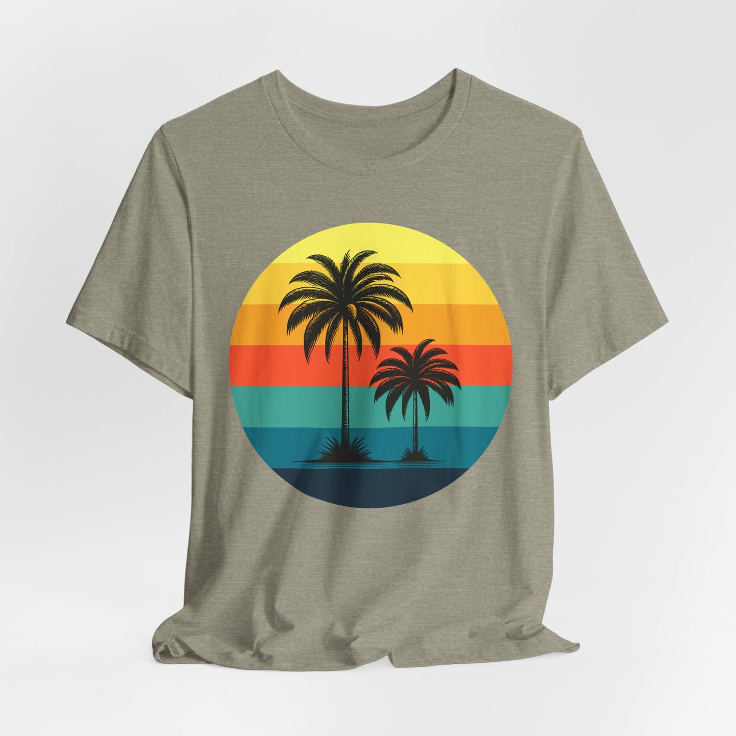 The Sunset Palm Trees Unisex Jersey T-Shirt - Vibrant Beach Vibe features a retro round graphic with two palm trees silhouetted against yellow, orange, red, and teal sunset stripes—great for tropical events or summer holidays.