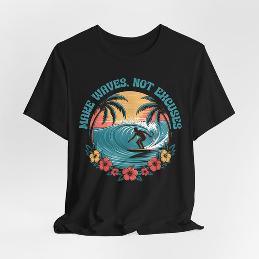The Surf Tee - Make Waves Not Excuses - Inspirational T-Shirt features a surfer riding a wave with palm trees, hibiscus, and a sunset, plus “MAKE WAVES, NOT EXCUSES” above—ideal for surfing or beach trips.